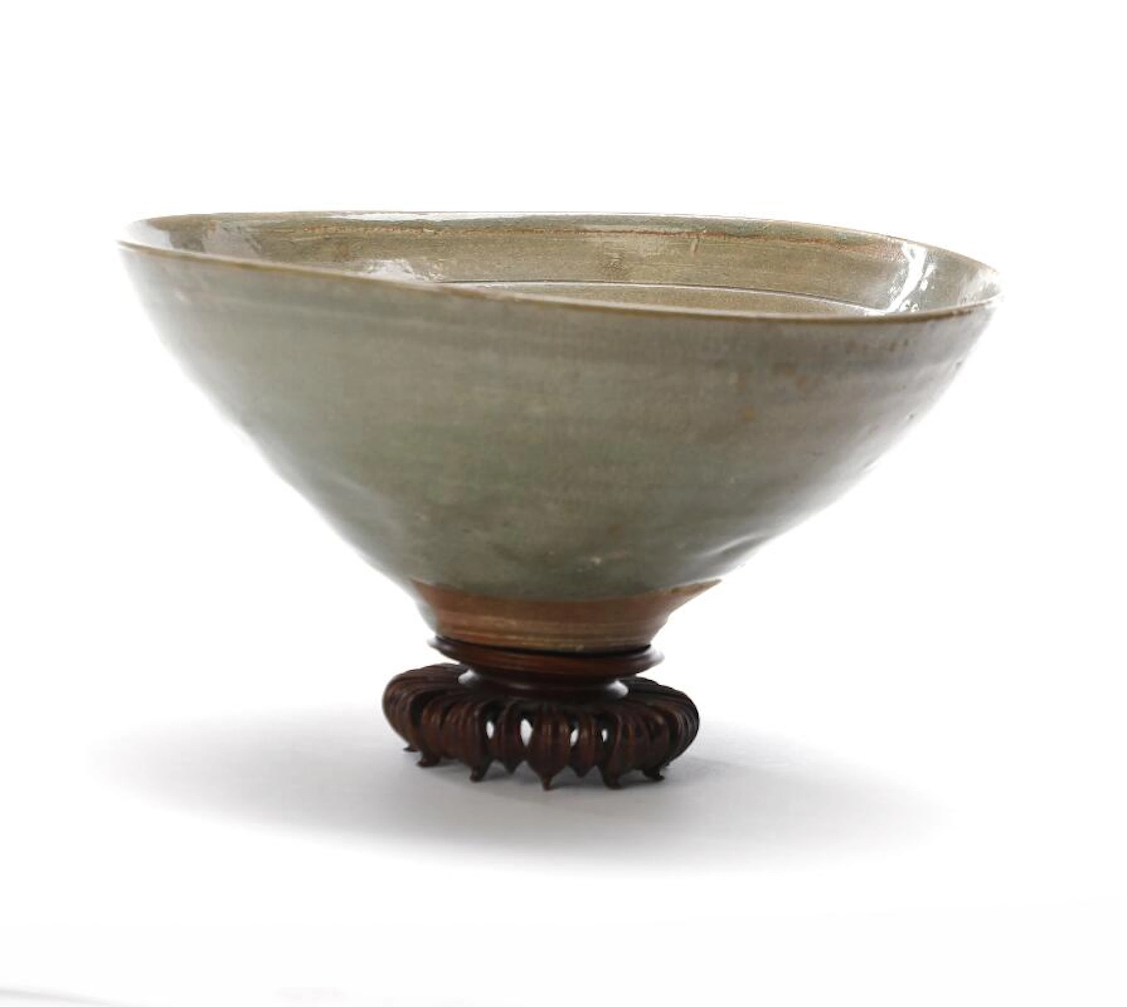 A celadon-glazed stoneware bowl of conical form