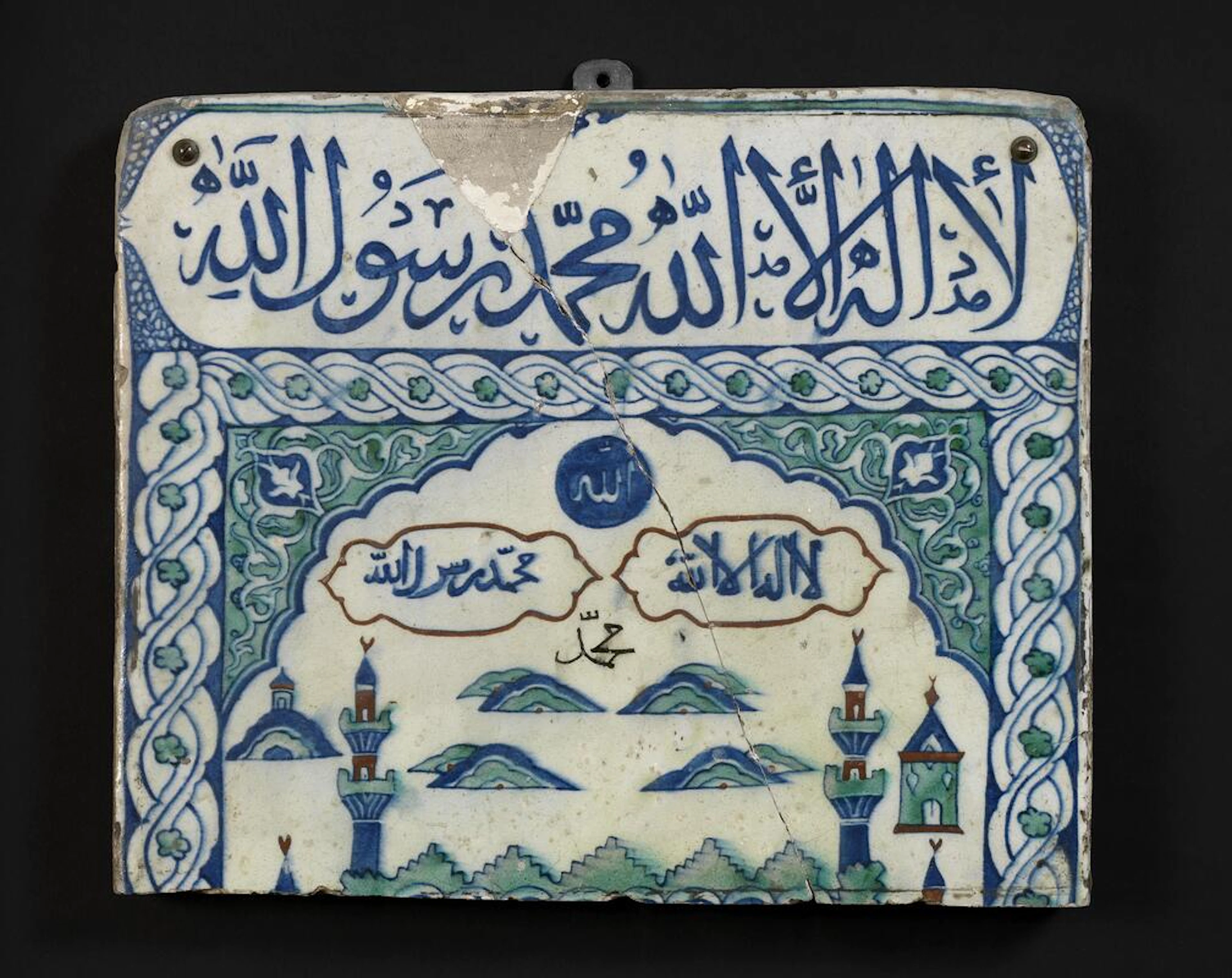 A half large pottery tile decorated in blue