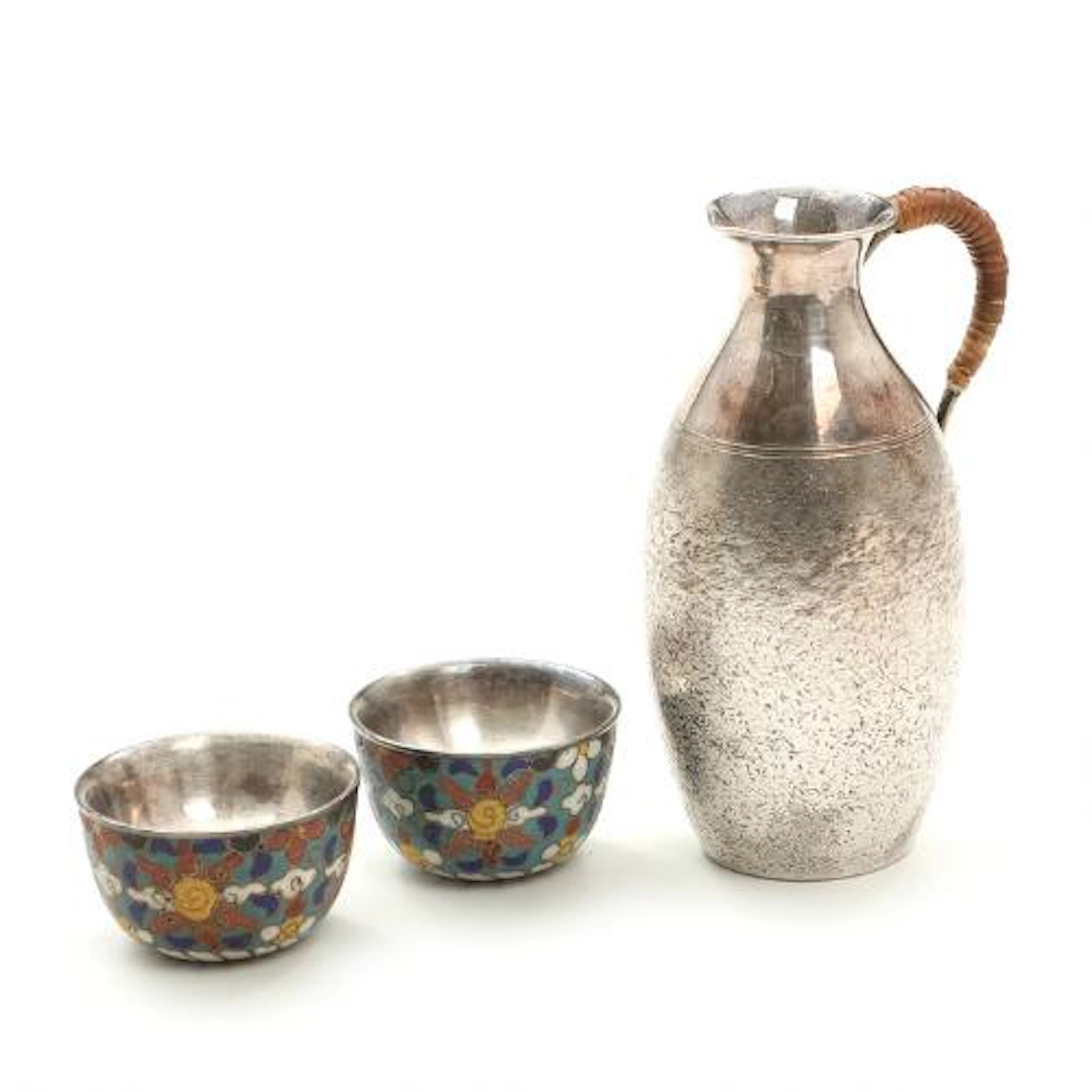A Japanese partly hammered silver sake pitcher with wicker