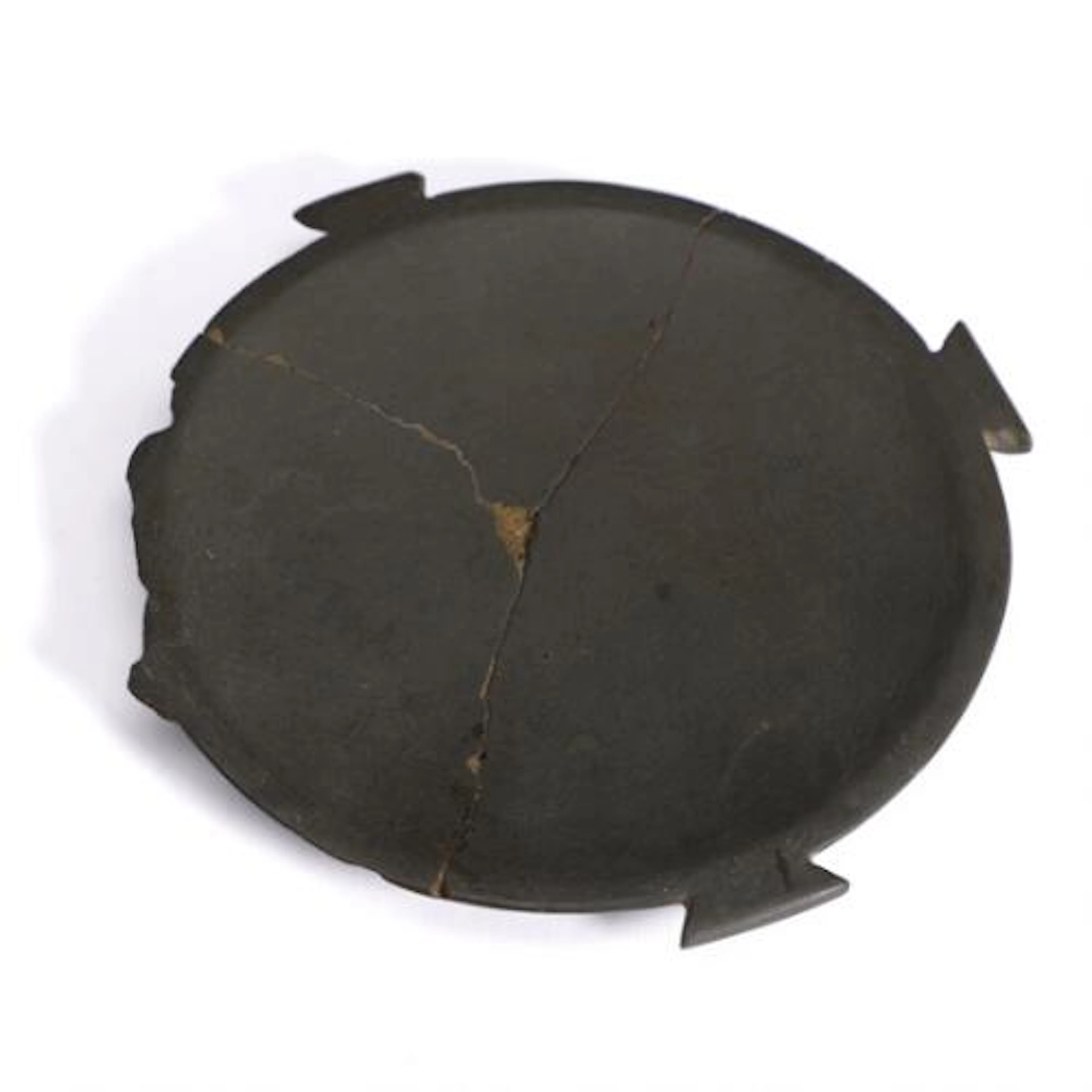 An Egyptian grey schist circular cosmetic palette with three