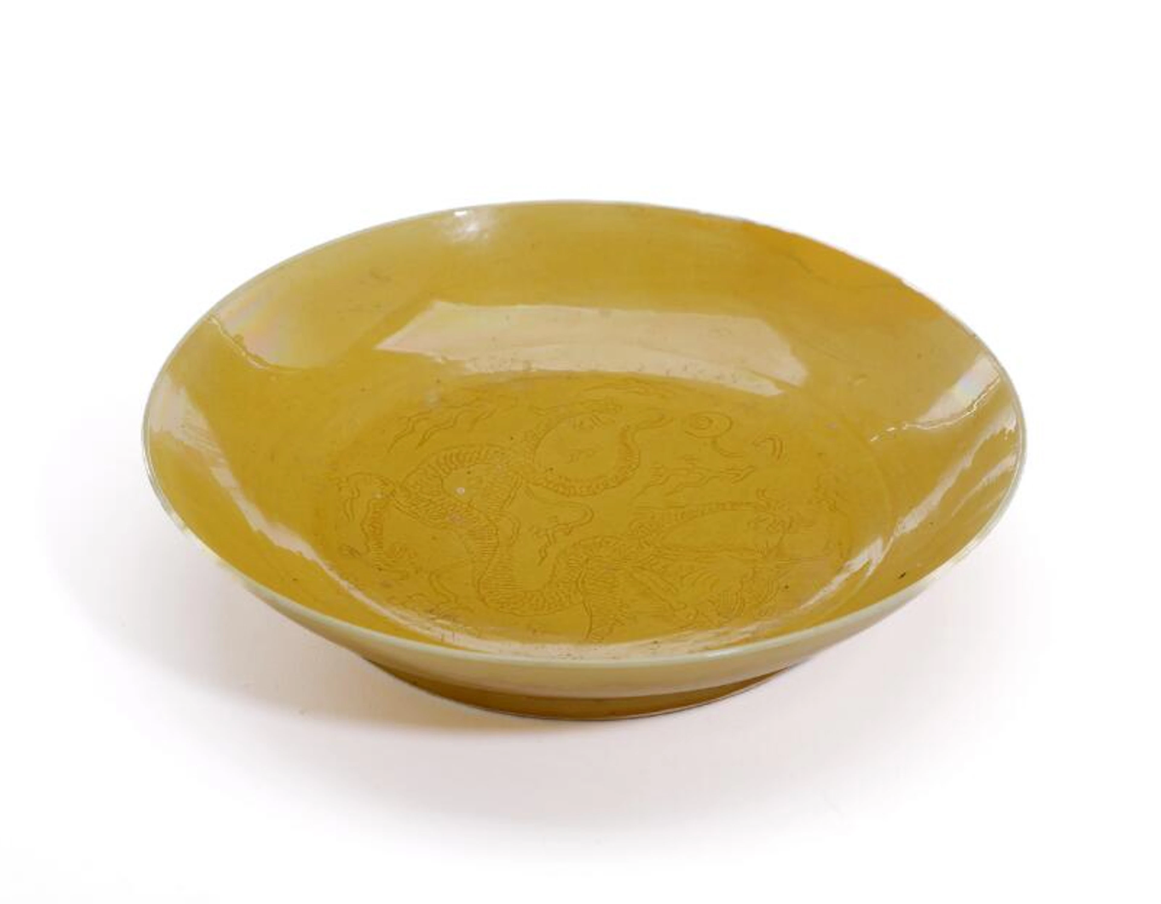 A Chinese yellow glazed dish the well with a five-clawed dragon