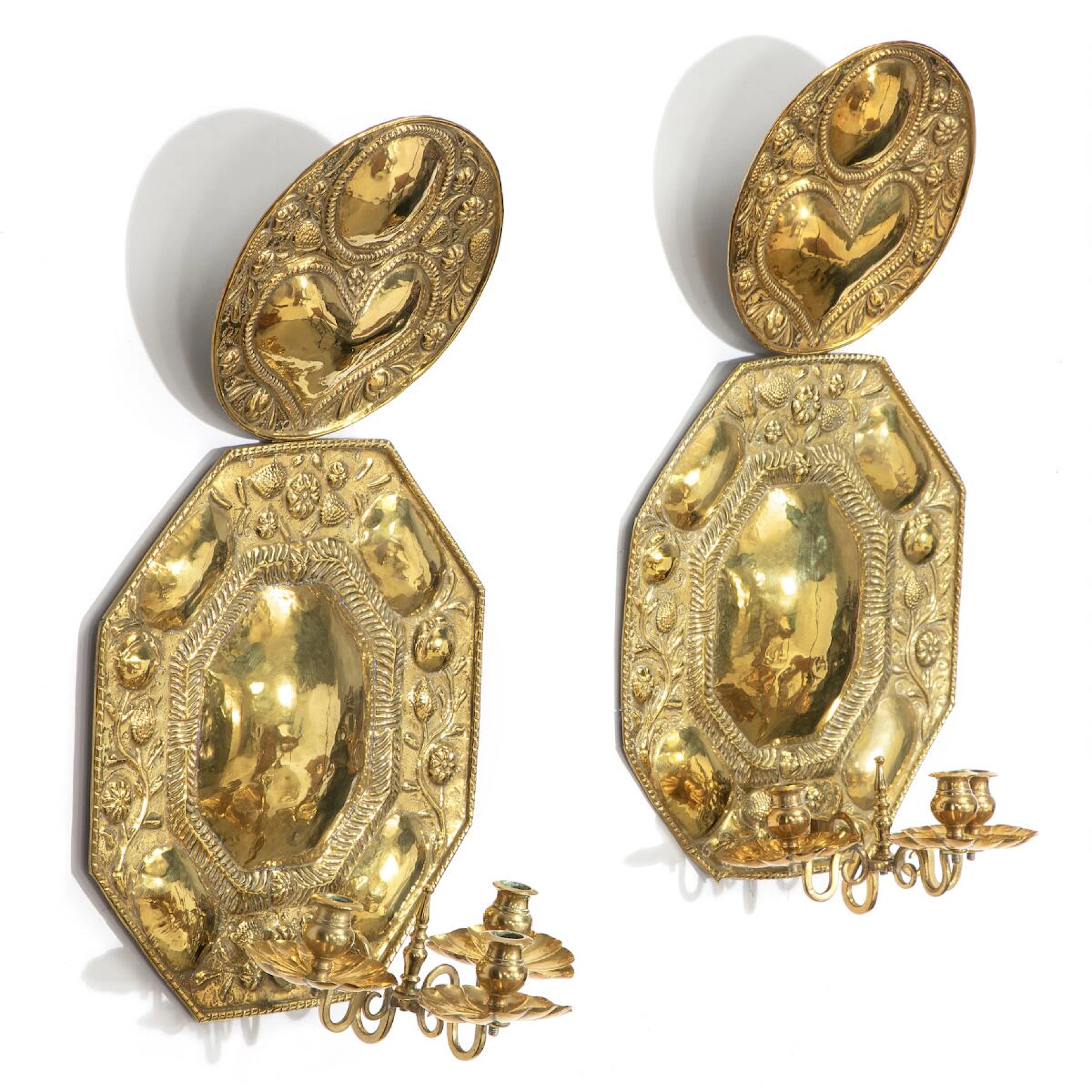 A pair of Frisian baroque shield shaped wall lights of molded and brushed brass