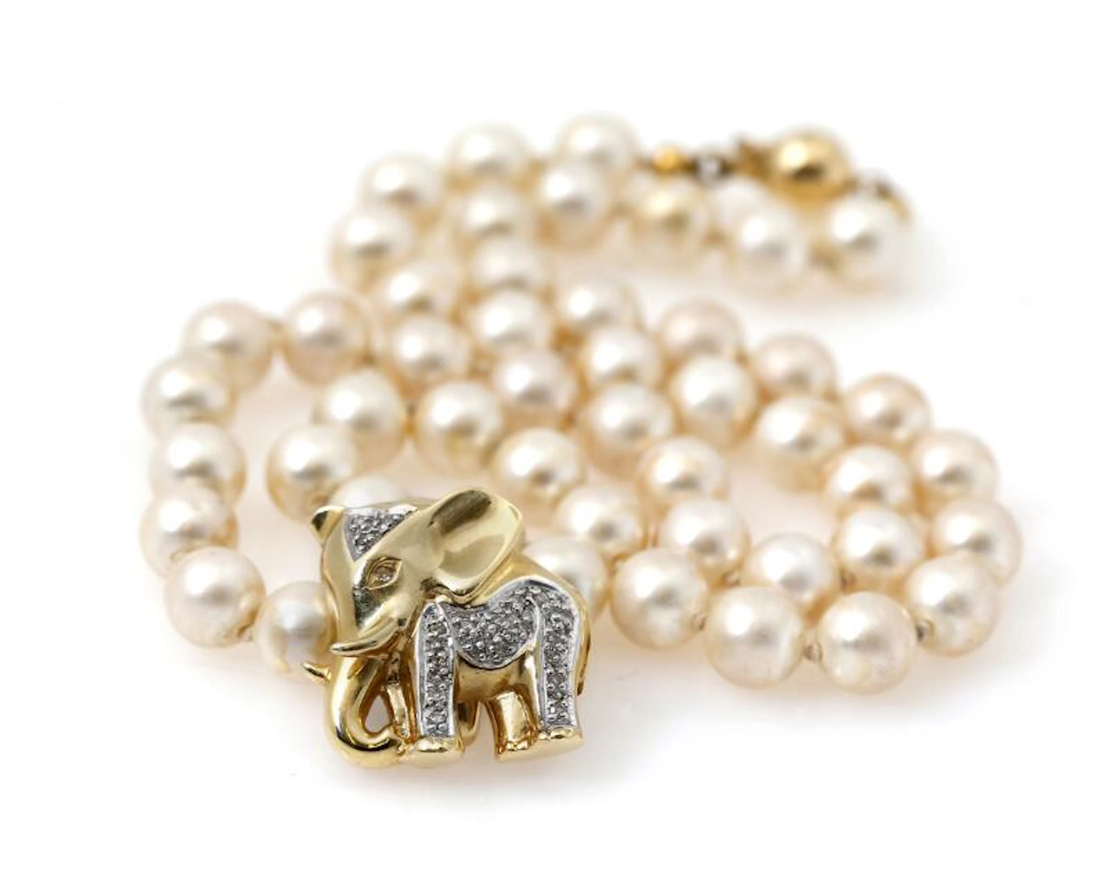 A pearl necklace set with numerous imitated pearls and a...