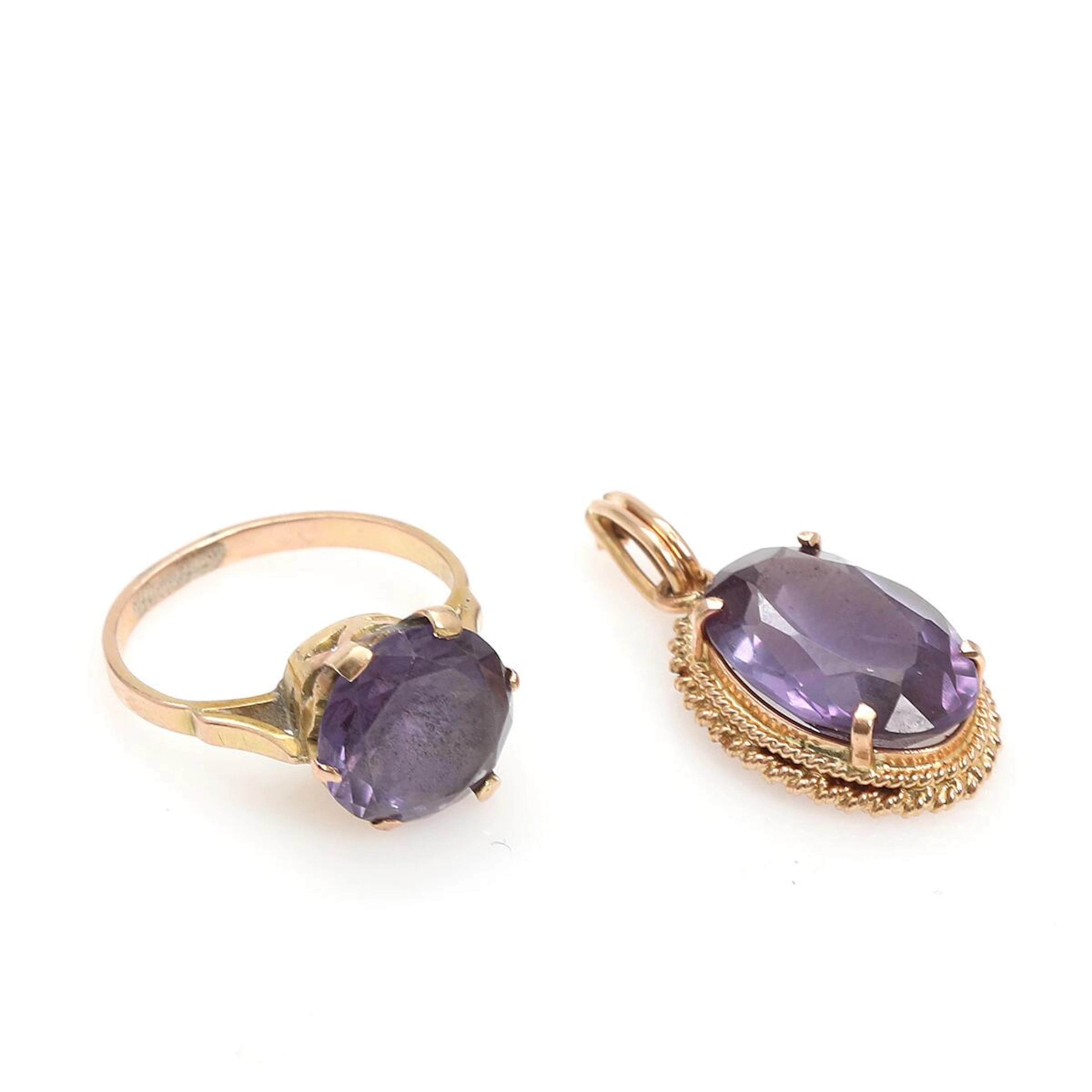A sapphire pendant and ring each set with a faceted syntetic purple sapphire