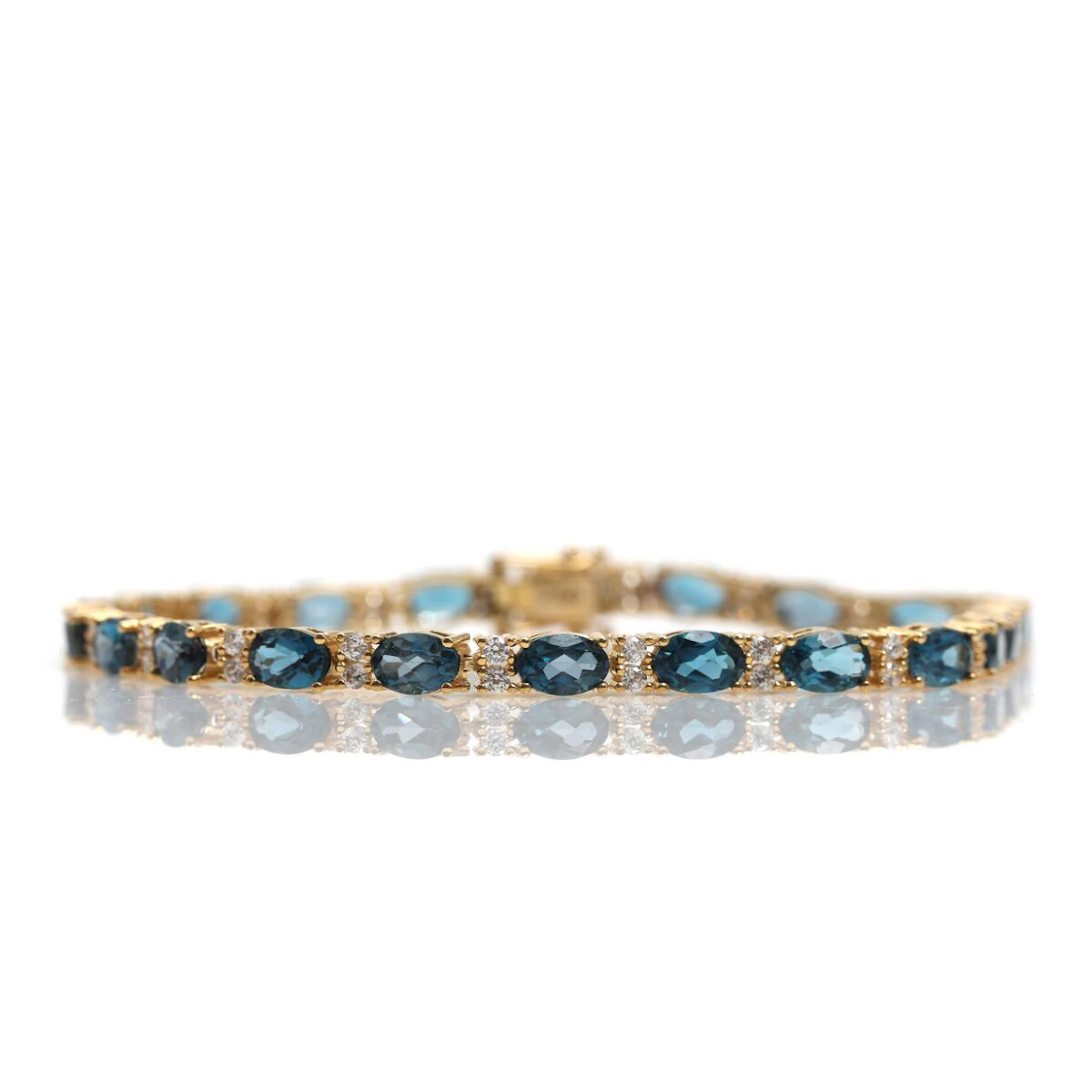 A spinel bracelet set with numerous faceted syntetic blue spinels and gem stones