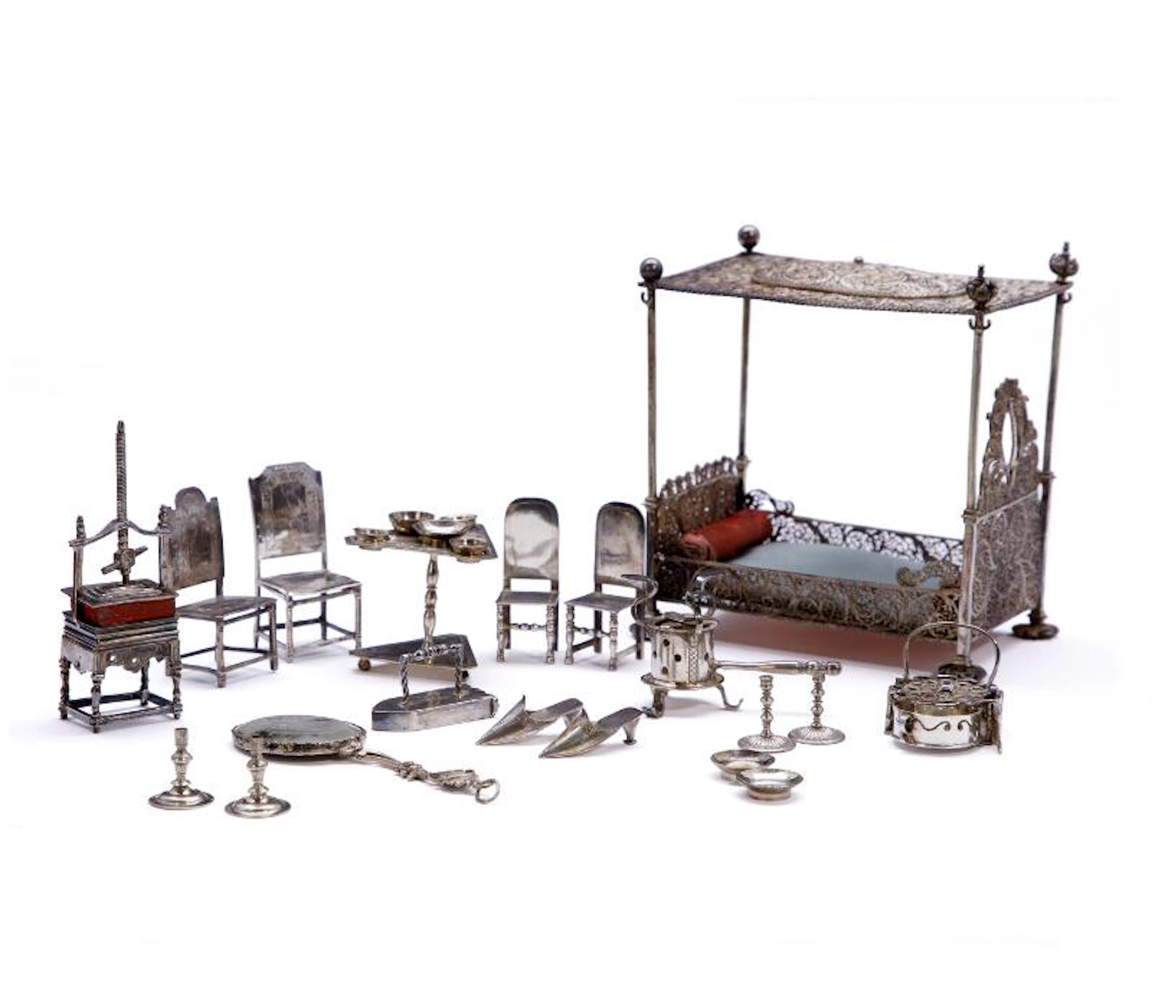A collection of silver miniature furniture comprising table