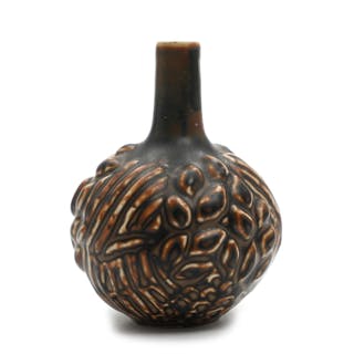 A stoneware vase with round base modelled with leaves and branches