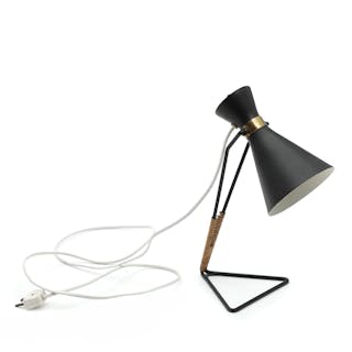 A table lamp with black lacquered metal base woven with cane