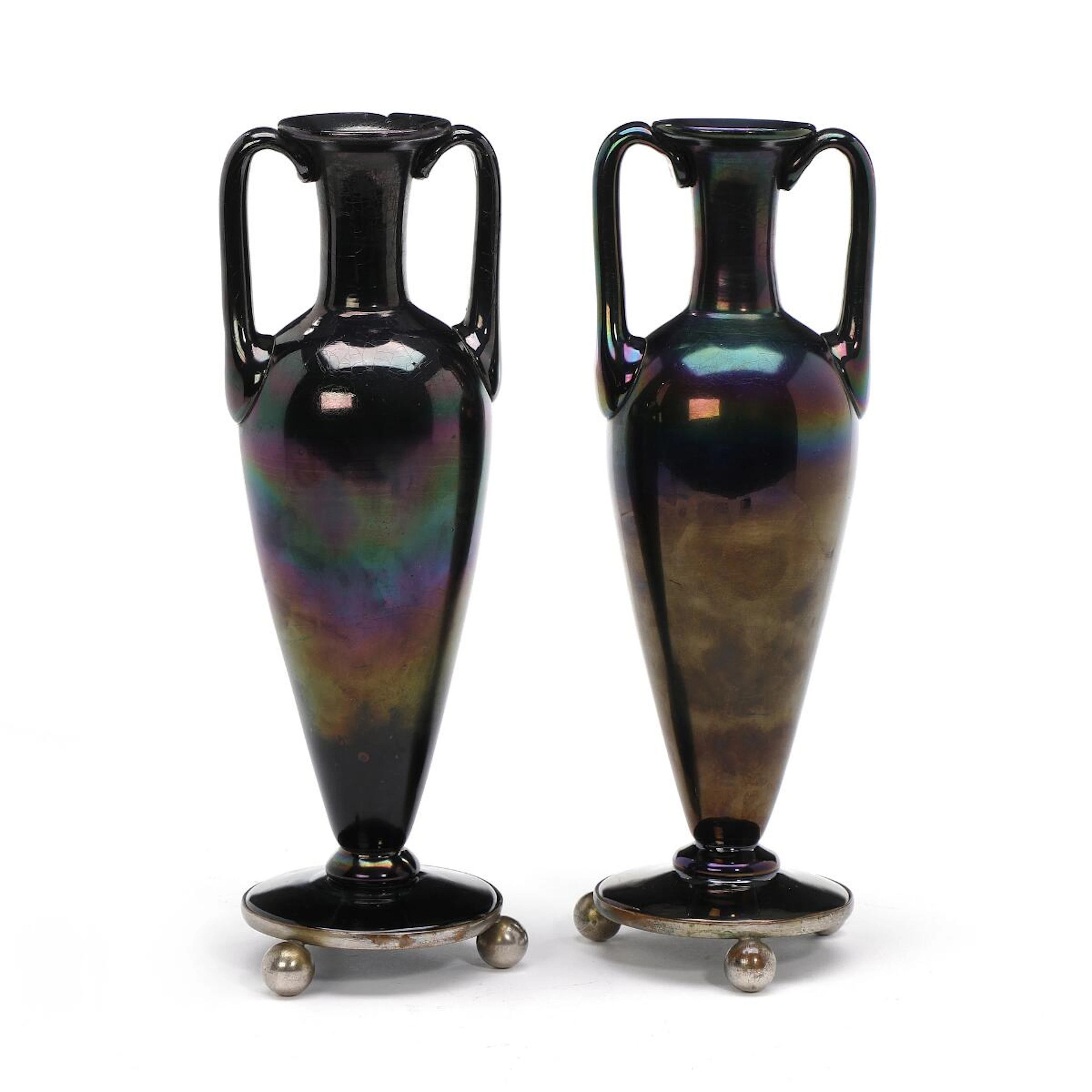 A pair of iridescent glass vases of amphora form