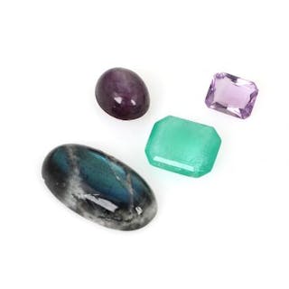 A collection of unmounted stones comprising an emerald, amethyst
