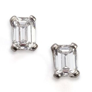 A pair of diamond ear studs each set with an emerald-cut diamond weighing