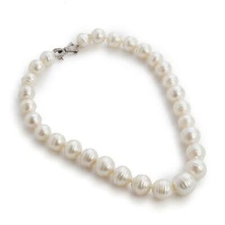 A pearl necklace set with numerous pearls and a clasp set with numerous