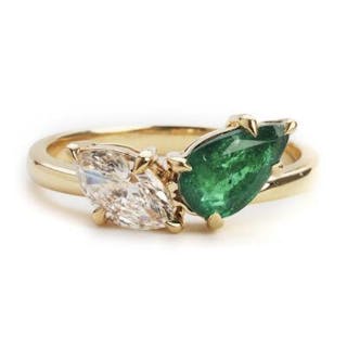 An emerald and diamond ring set with an emerald weighing app. 0.89
