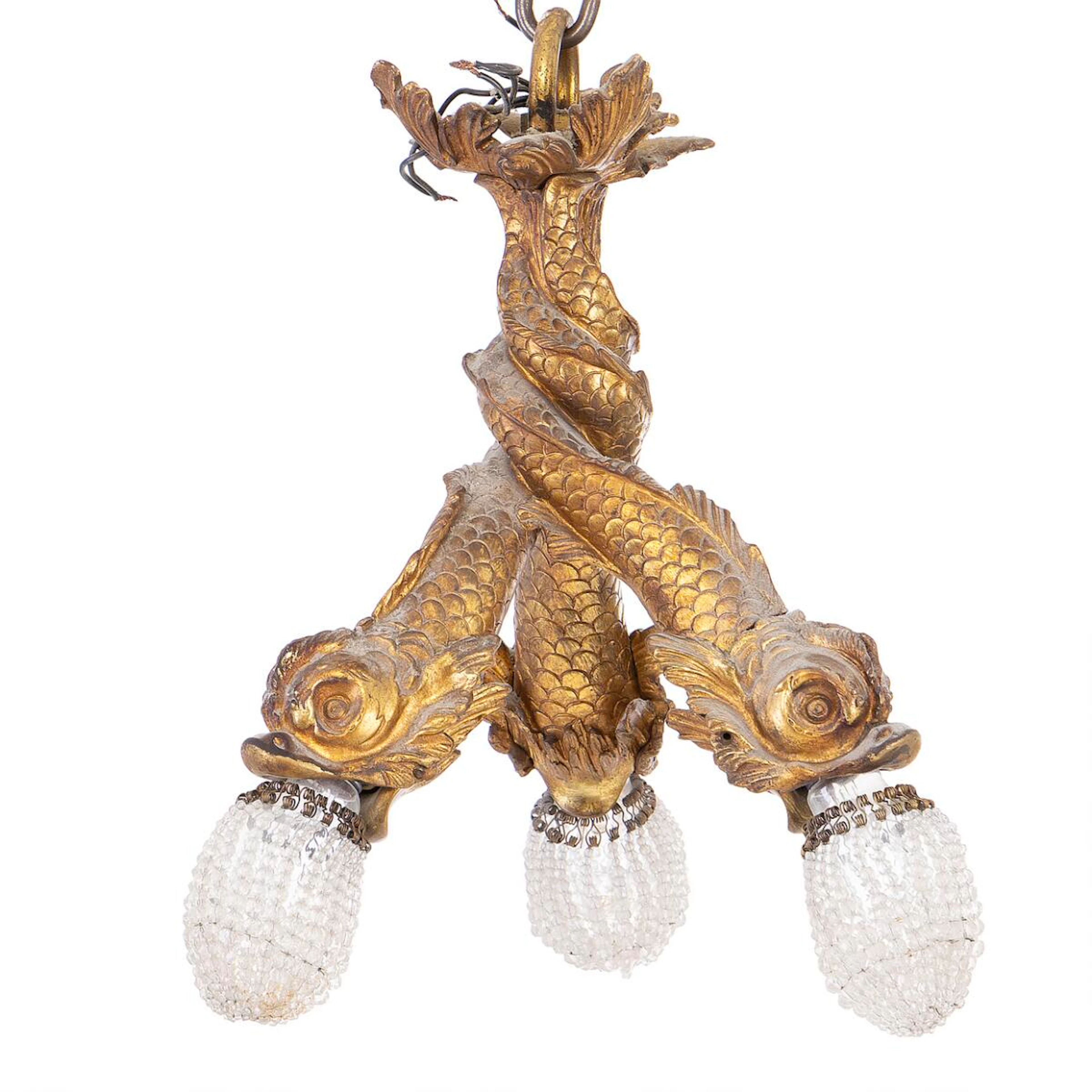 A gilt bronze chandelier in the shape of three fish