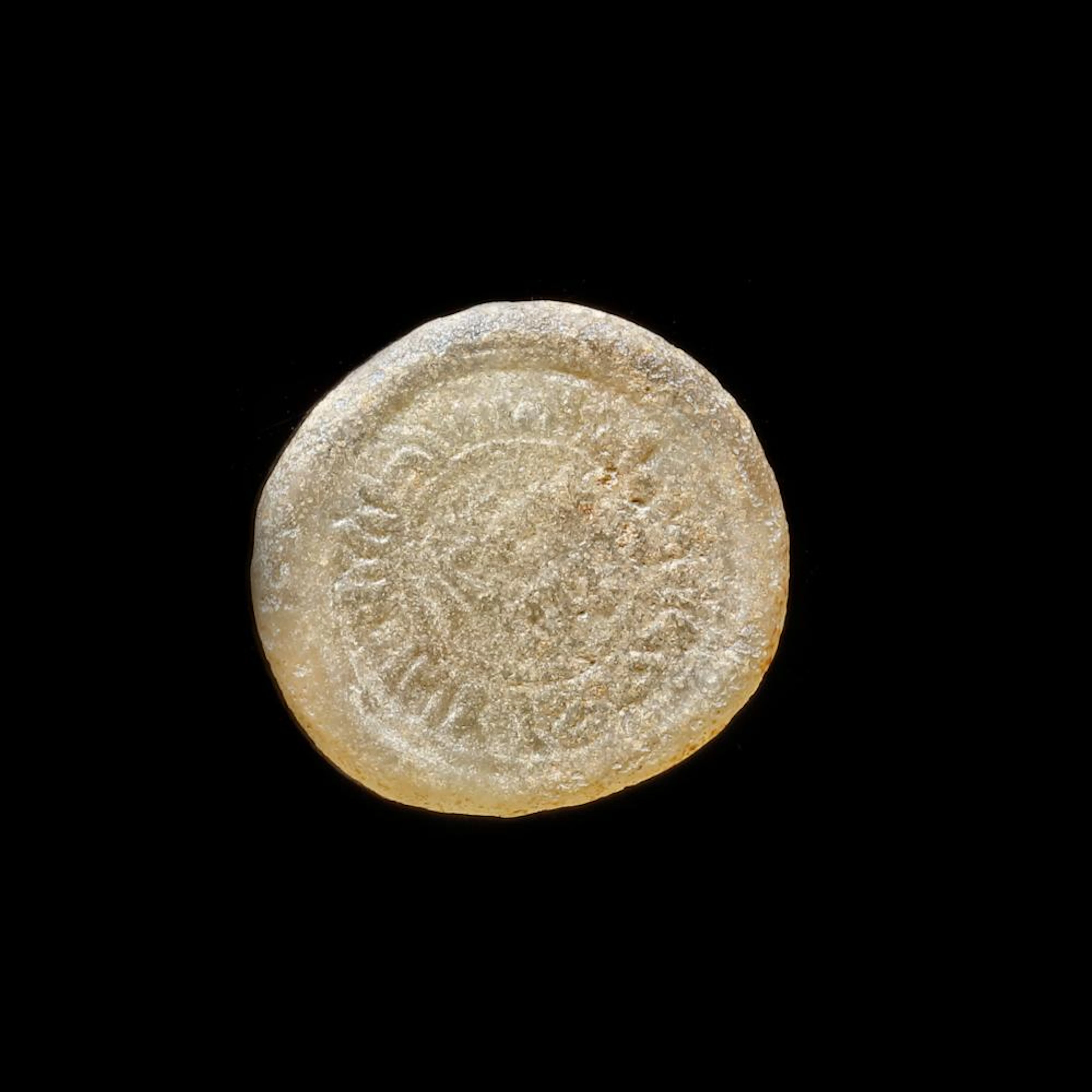 A FATIMID GLASS WEIGHT OF DIRHAM