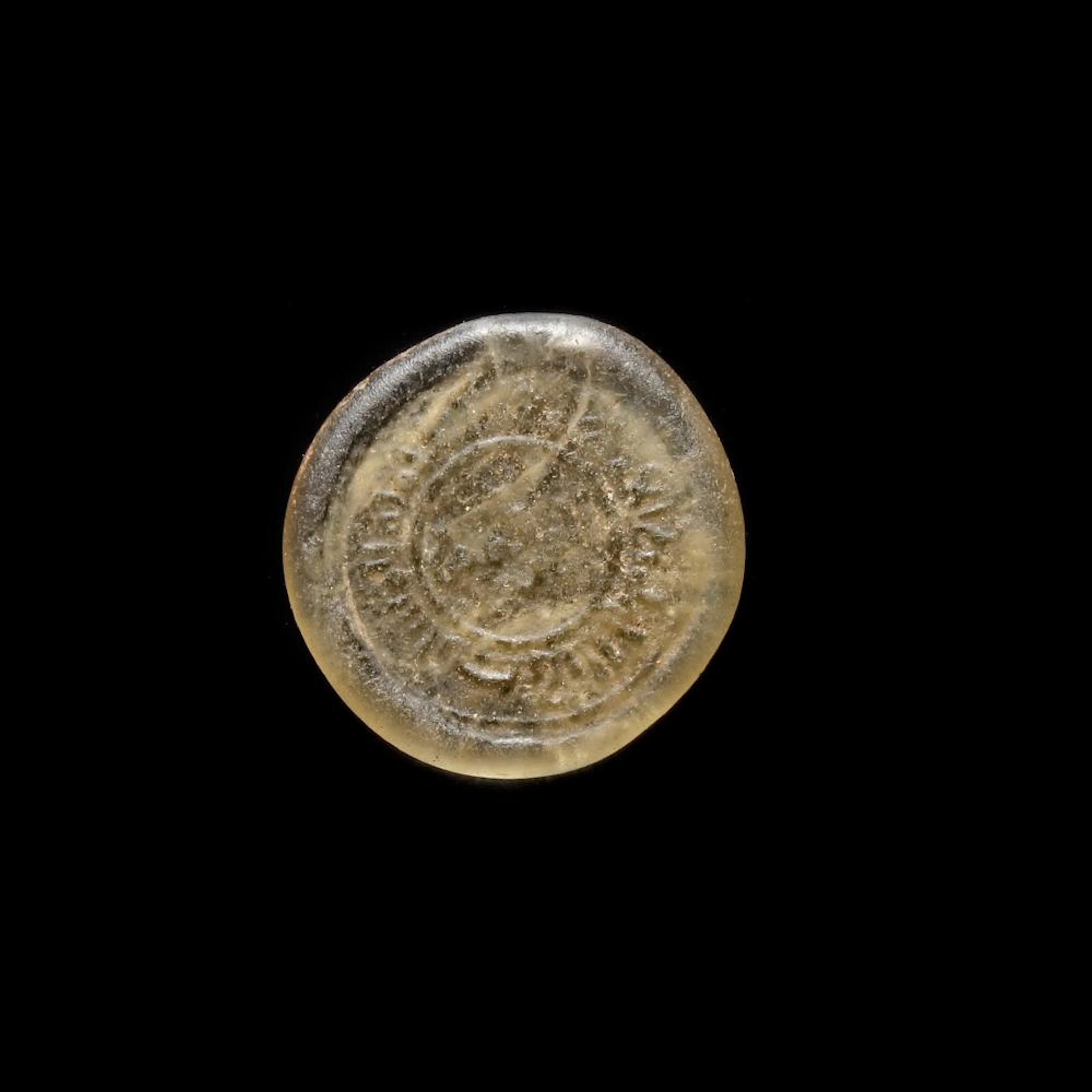 A FATIMID GLASS WEIGHT OF DIRHAM