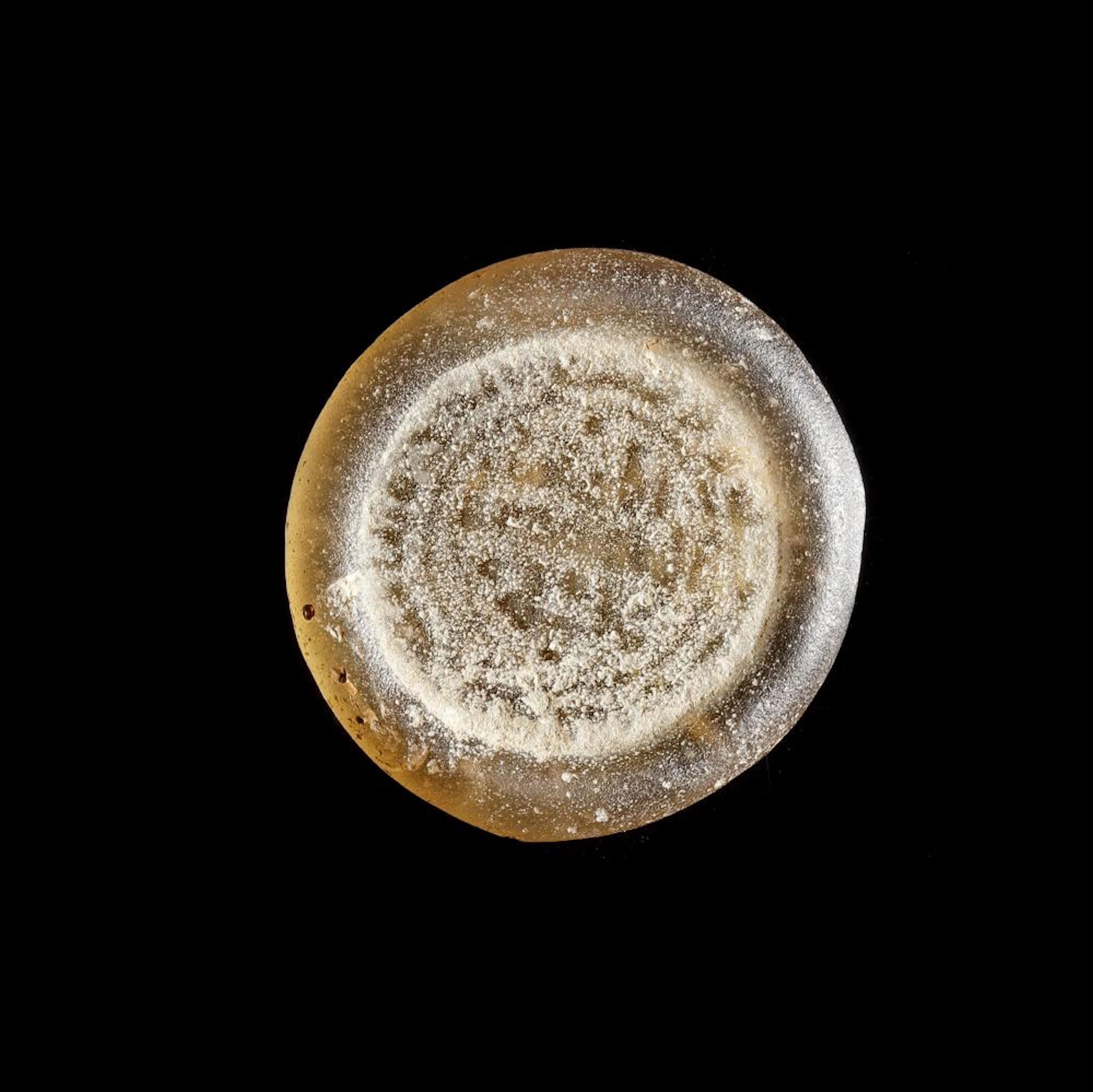 A FATIMID GLASS WEIGHT OF DOUBLE DIRHAM