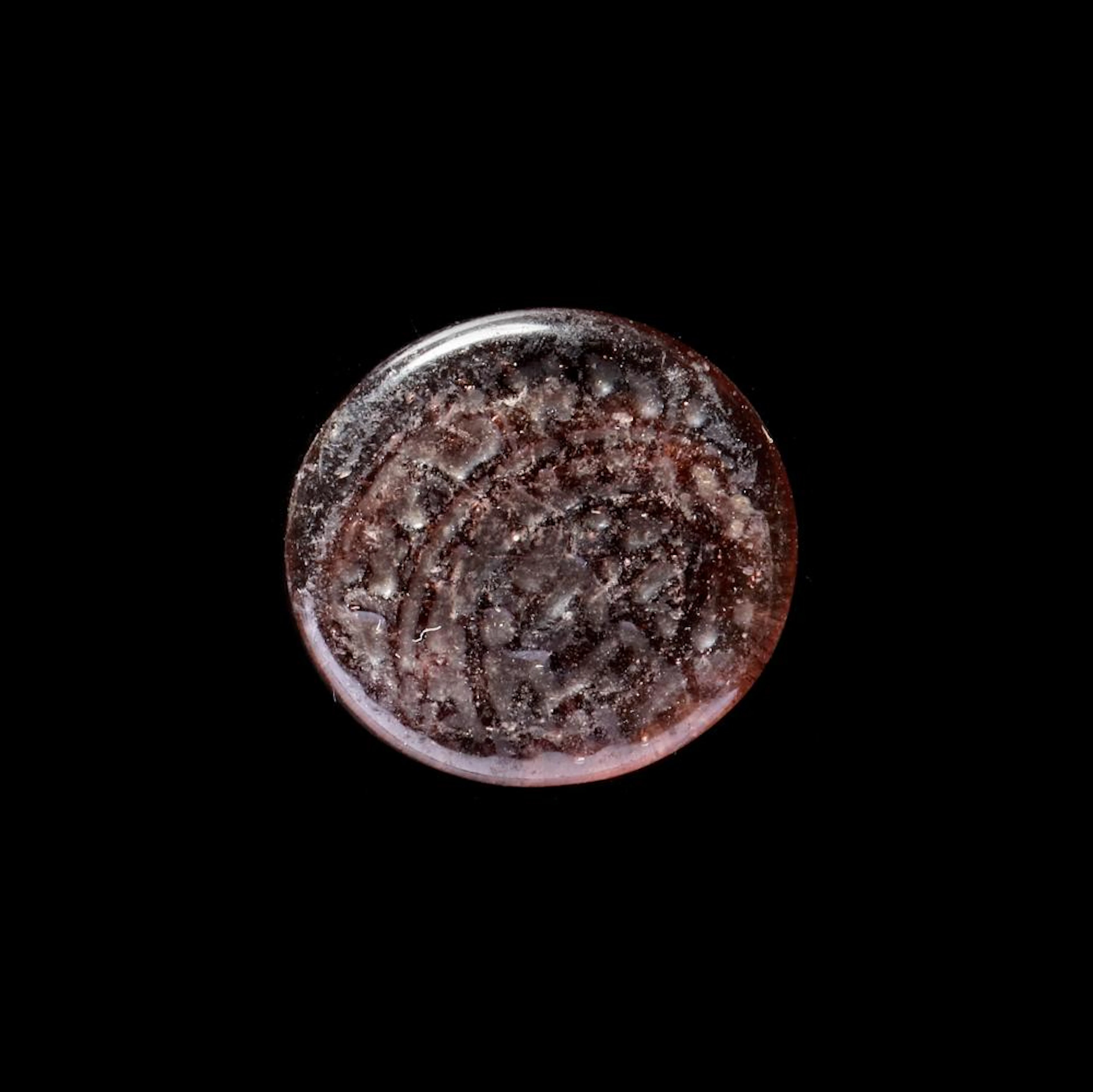 A FATIMID GLASS WEIGHT OF QUARTER DINAR