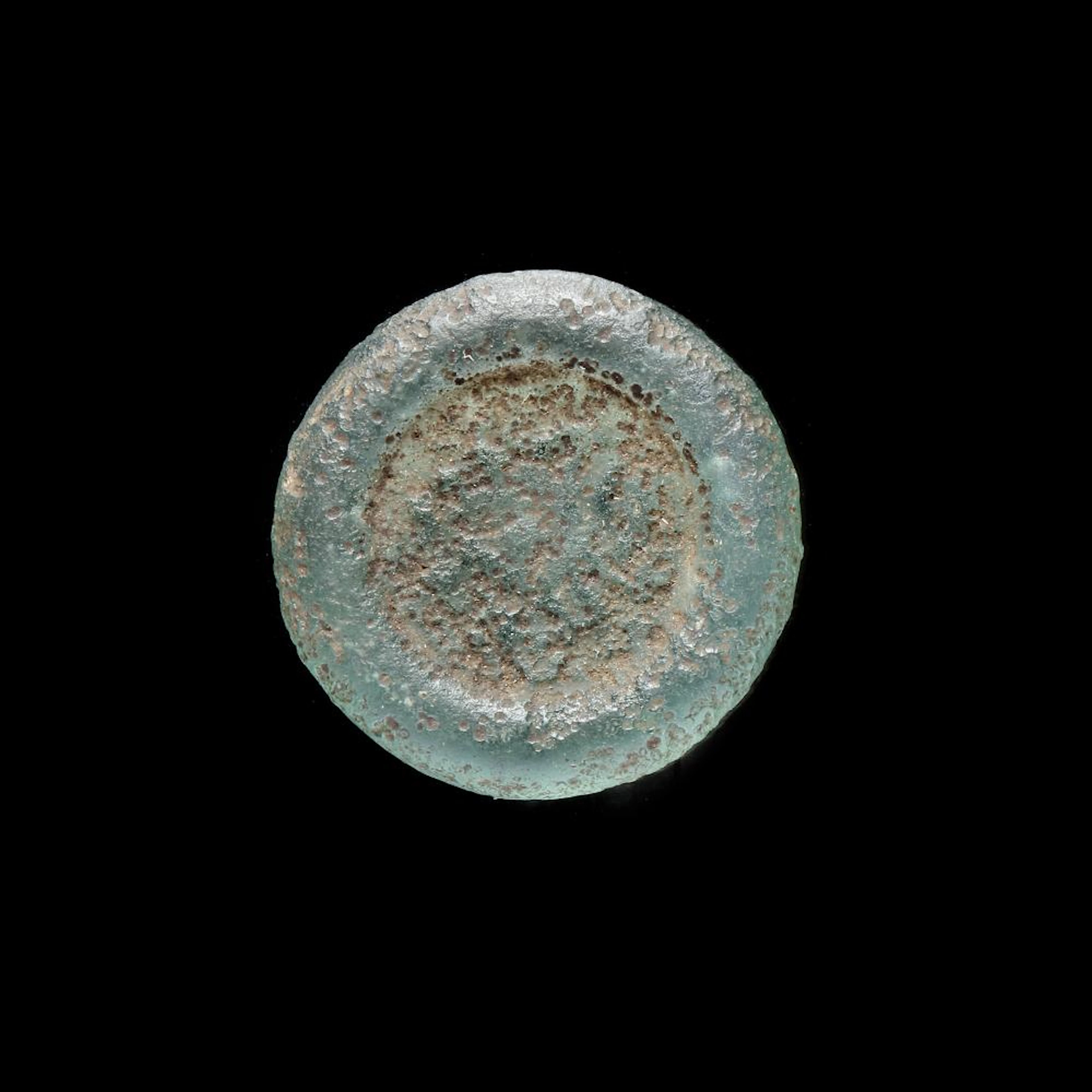 A FATIMID GLASS WEIGHT OF DIRHAM