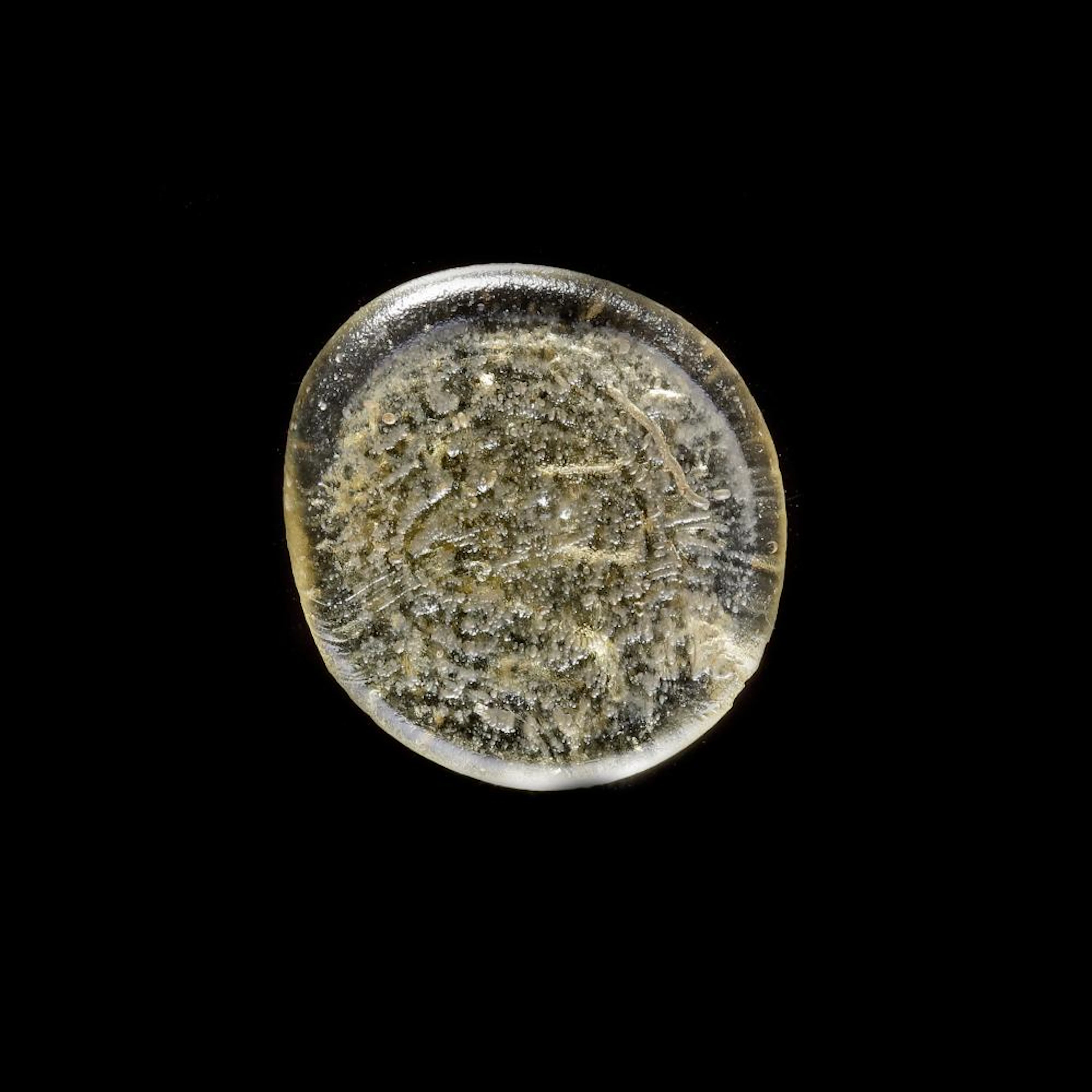 A FATIMID GLASS WEIGHT OF DINAR
