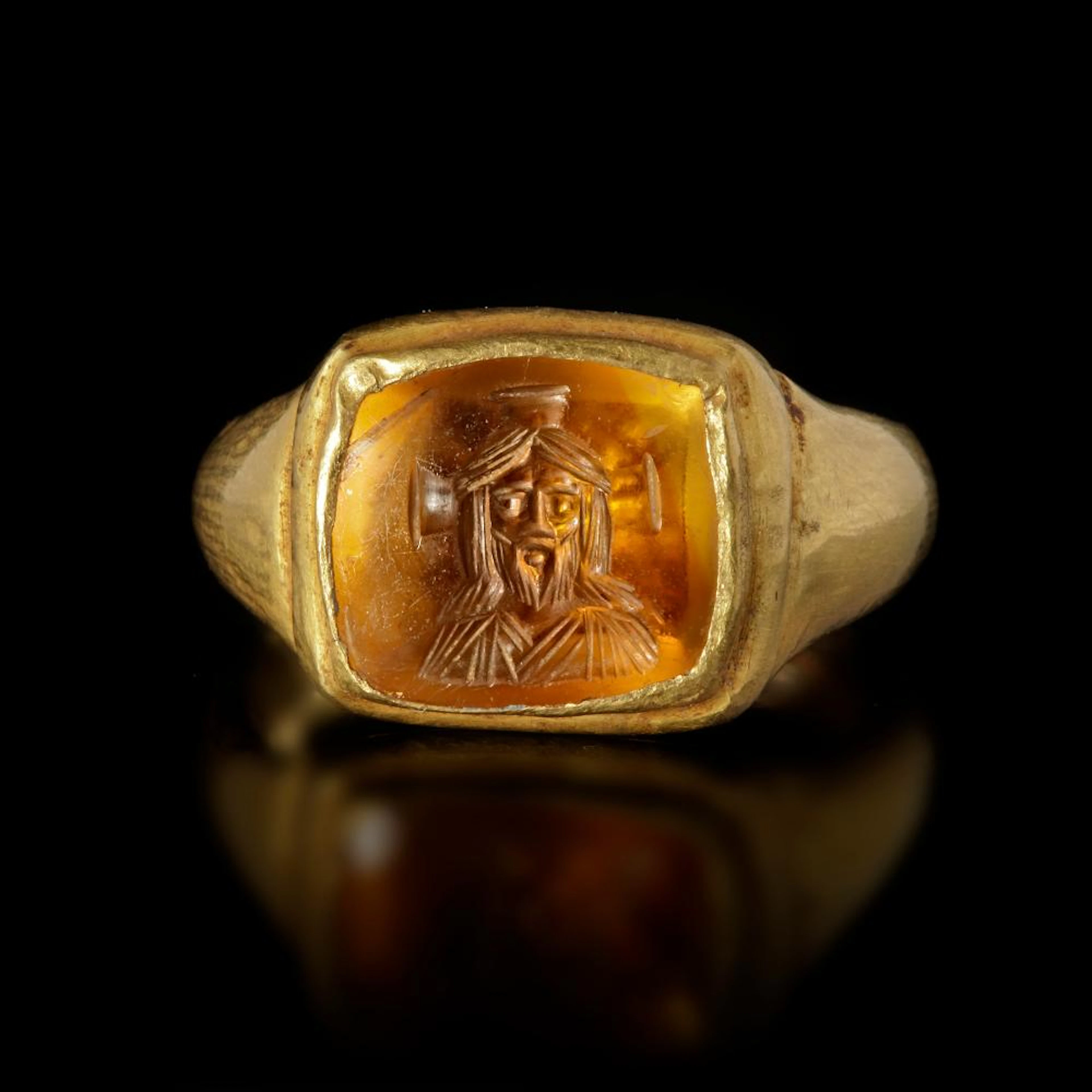 A BYZANTINE GOLD RING WITH A TOPAZ INTAGLIO WITH A BUST OF CHRIST