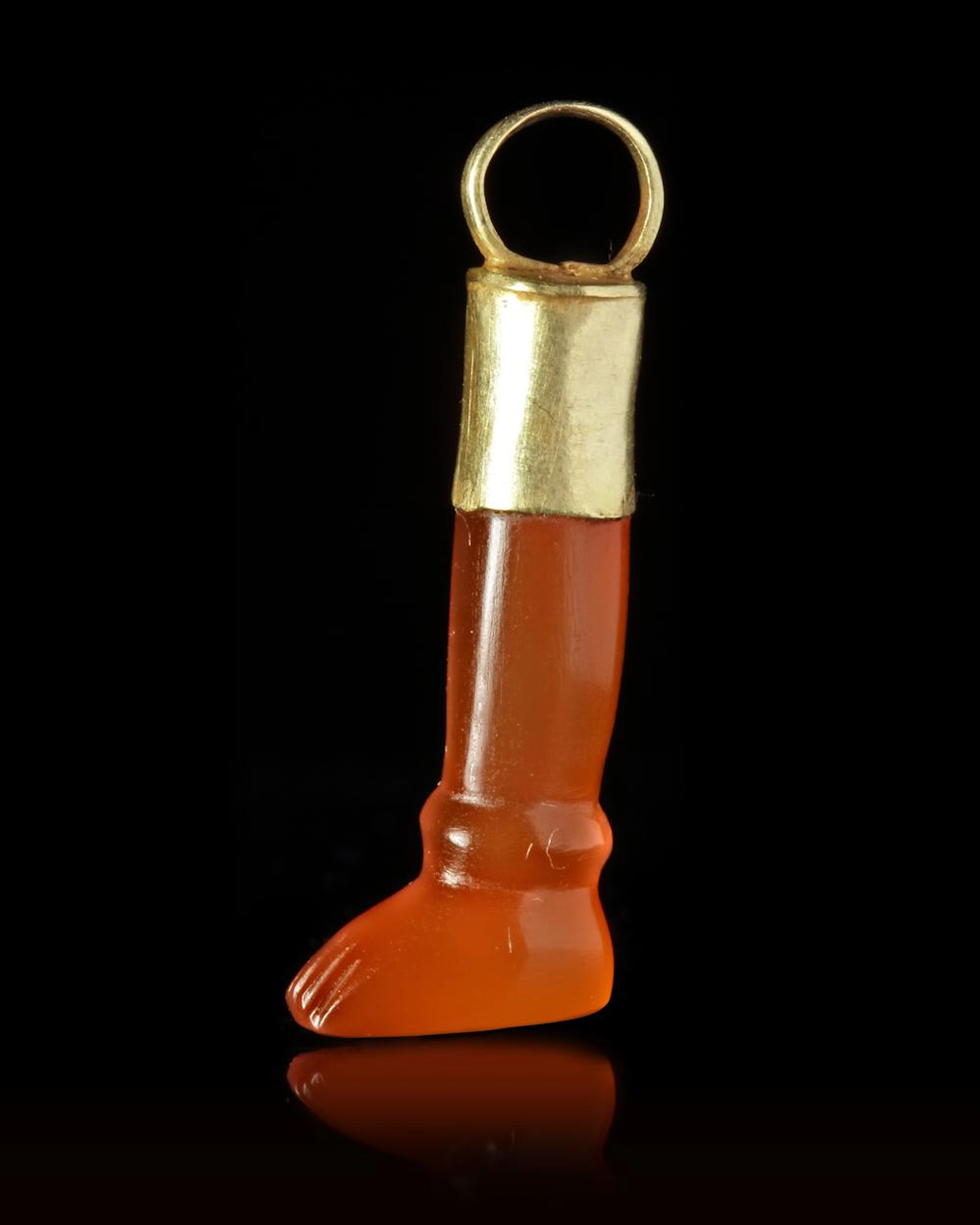 A CARNELIAN AMULET/SEAL IN THE SHAPE OF A LEG, CIRCA 700 BC
