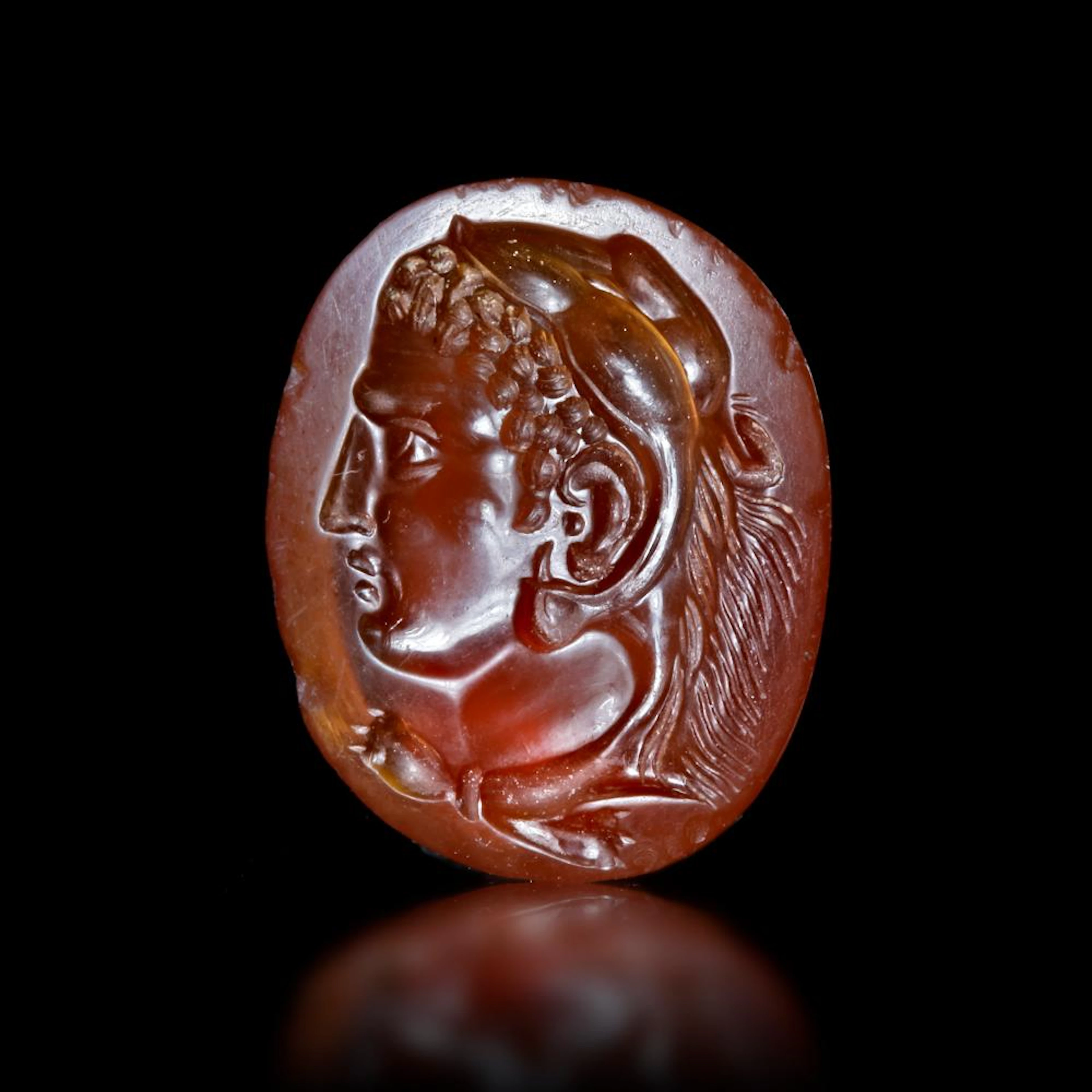 A ROMAN INTAGLIO WITH THE HEAD OF HERCULES POSSIBLY...