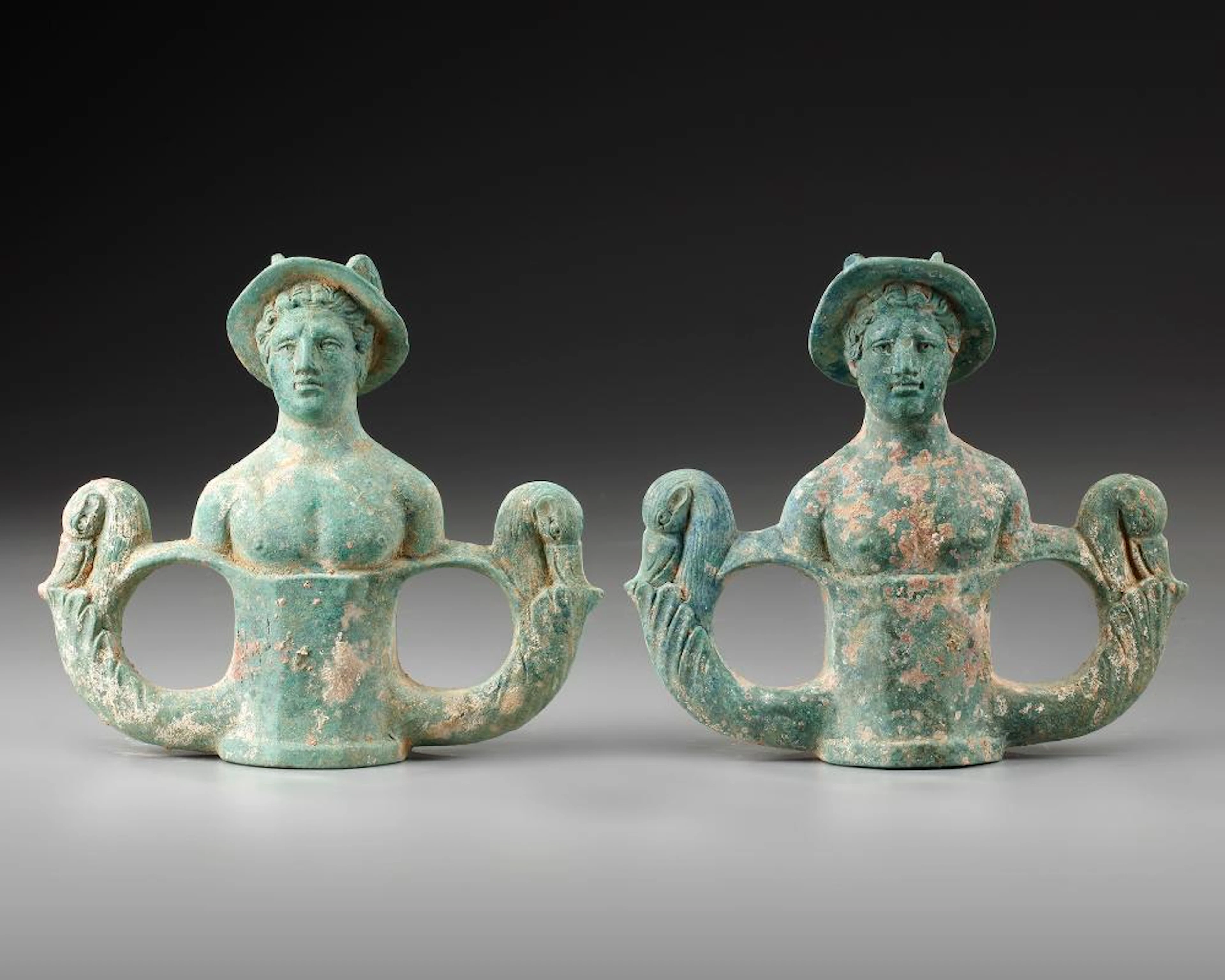 A PAIR OF BRONZE CHARIOT FITTINGS WITH THE BUSTS OF MERCURY