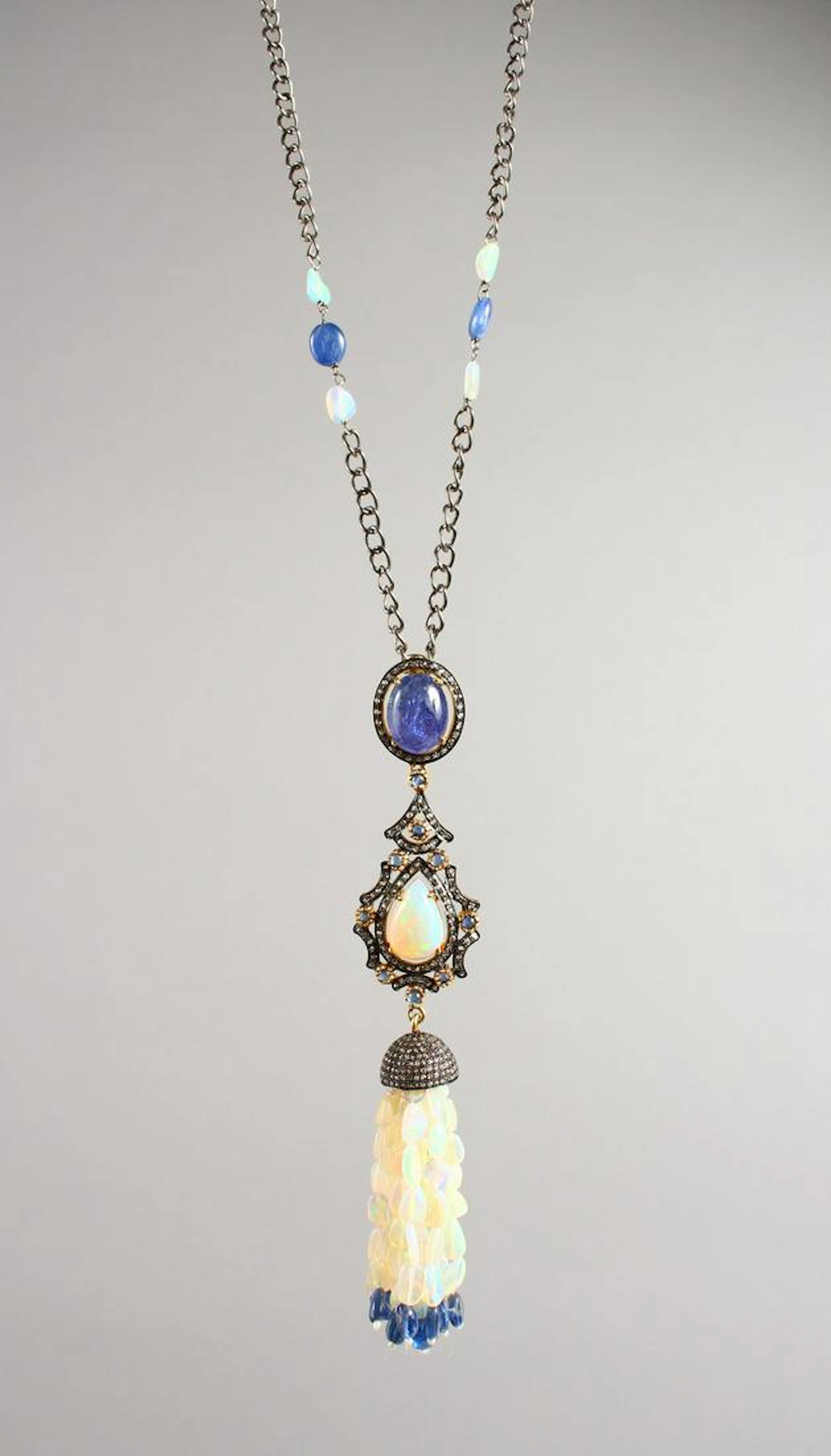 A diamond, opal, kyanite and tanzanite necklace.