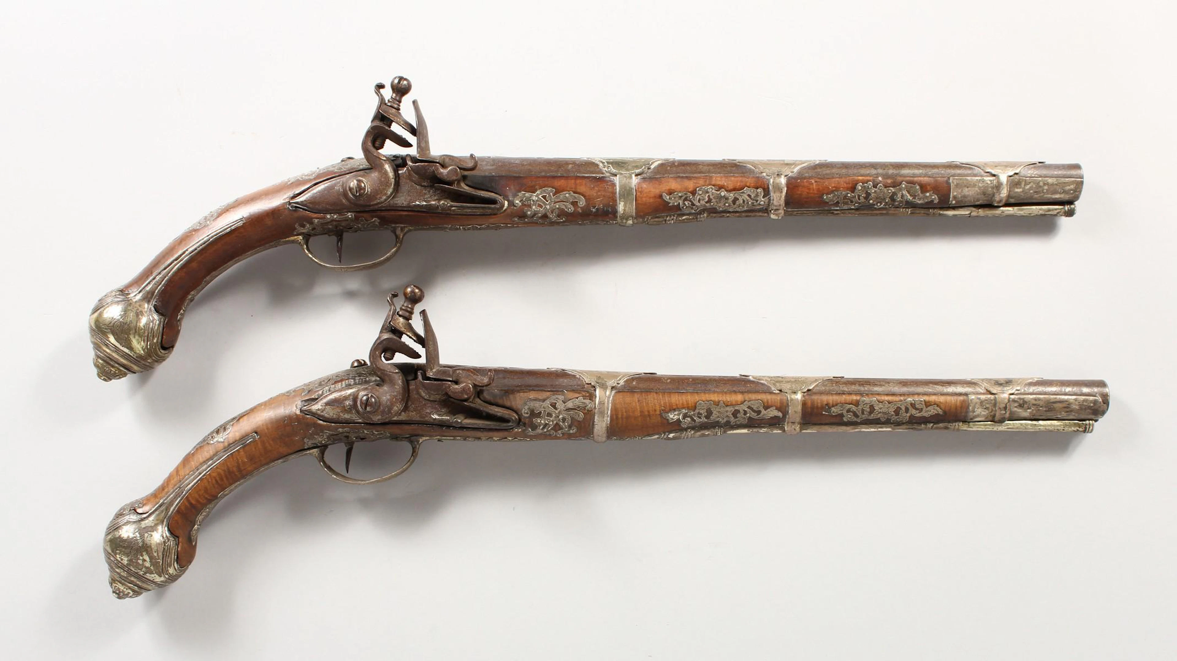 A PAIR OF EARLY 18TH CENTURY TURKISH SILVER MOUNTED