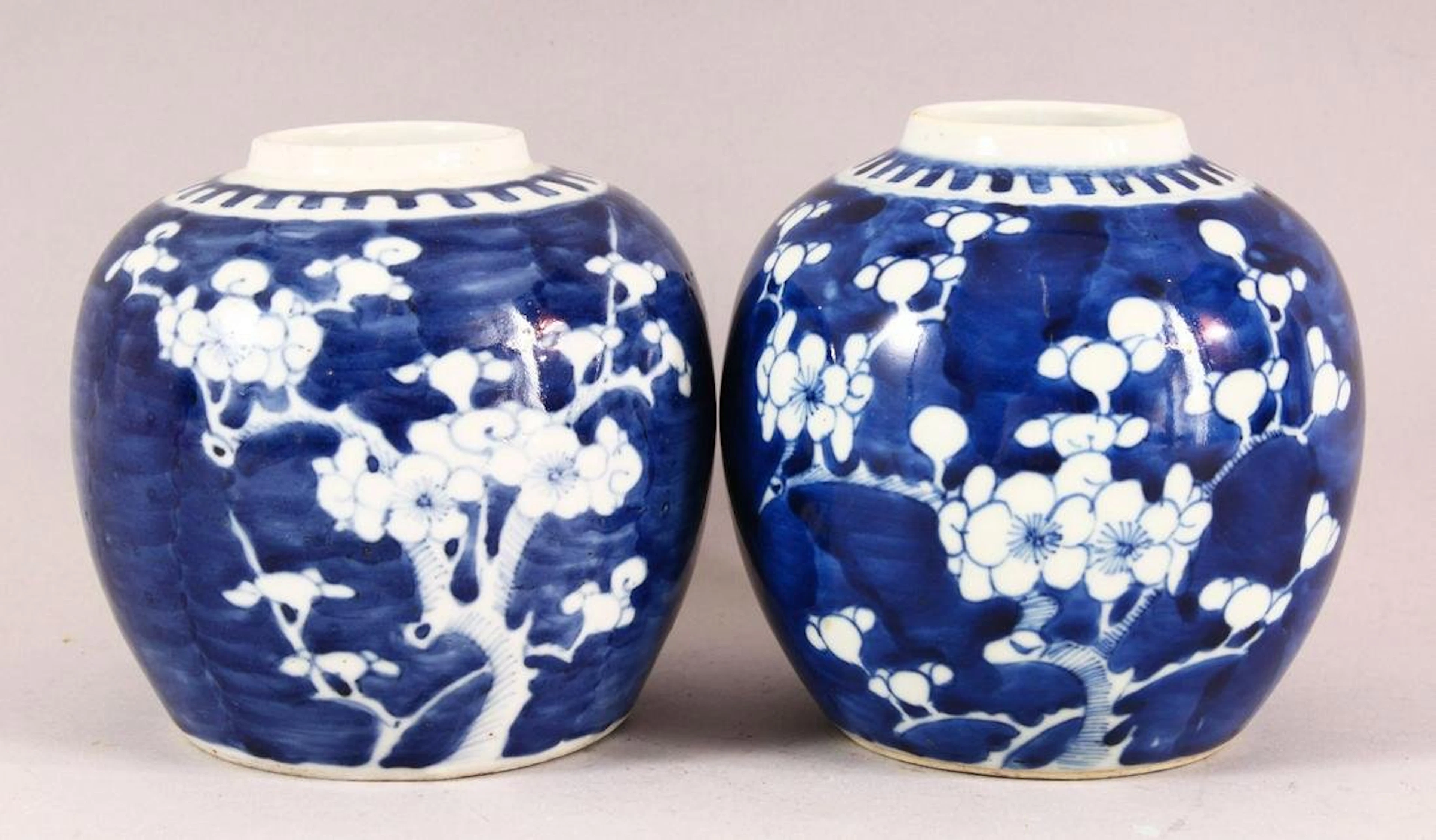 TWO CHINESE BLUE AND WHITE PRUNUS GINGER JARS, 13cm