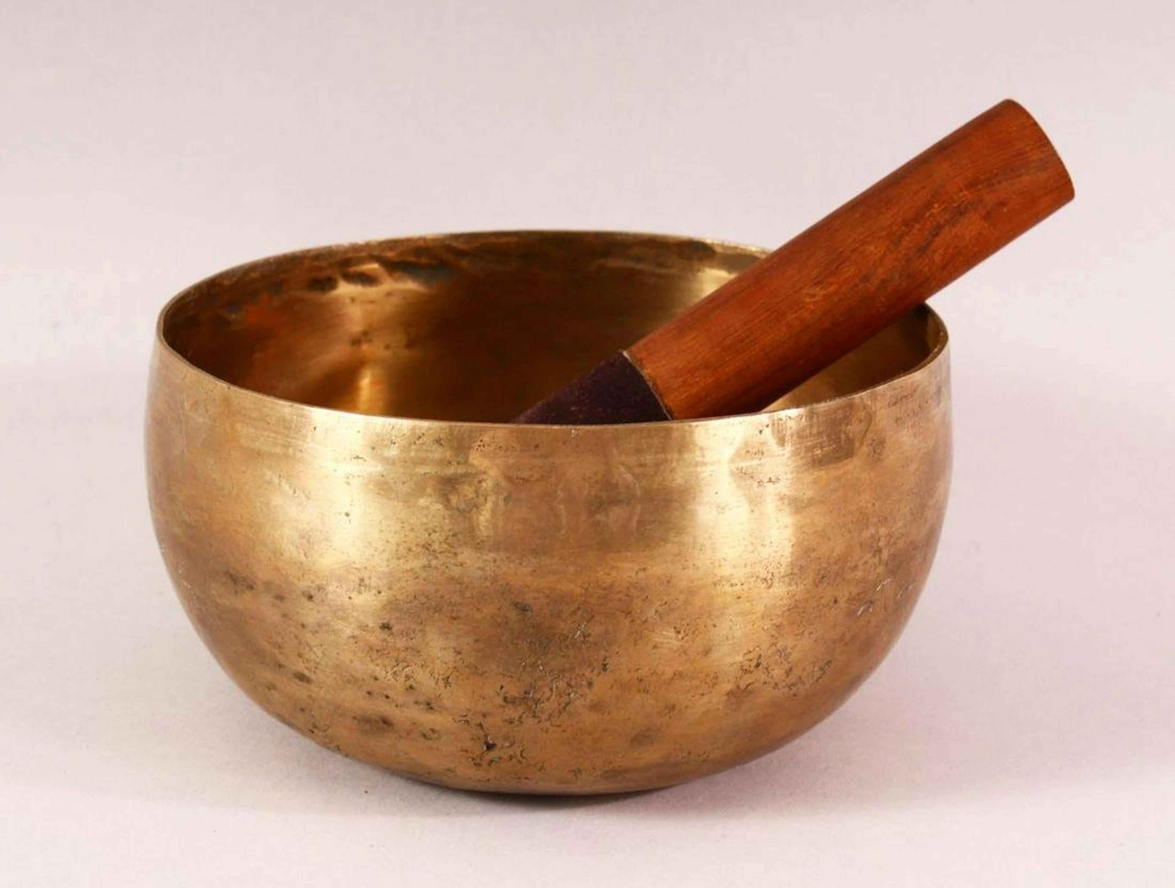 A 19TH CENTURY CHINESE TIBETAN BRASS MUSIC BOWL AND