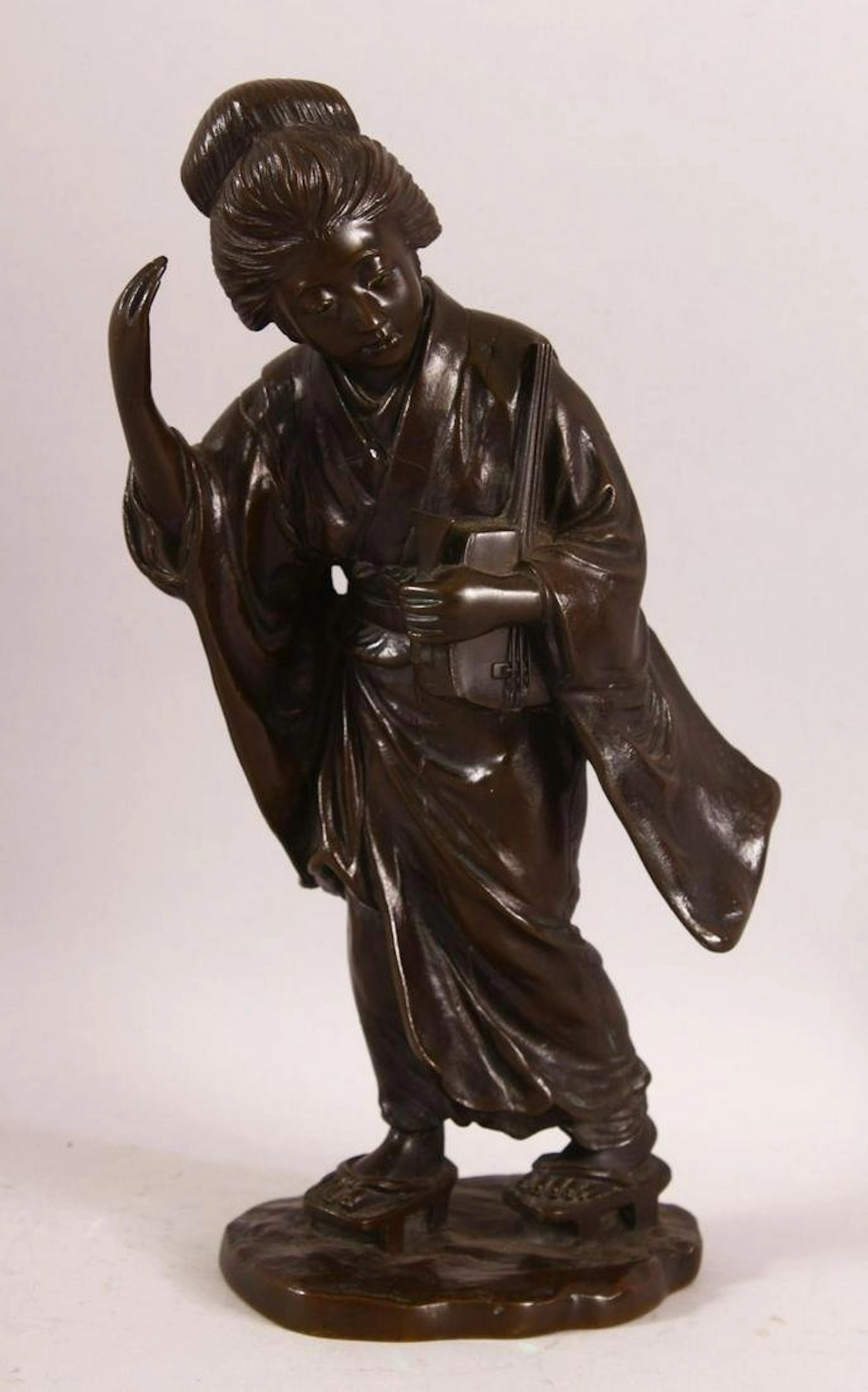 A GOOD JAPANESE MEIJI BRONZE FIGURE OF A GEISHA holding