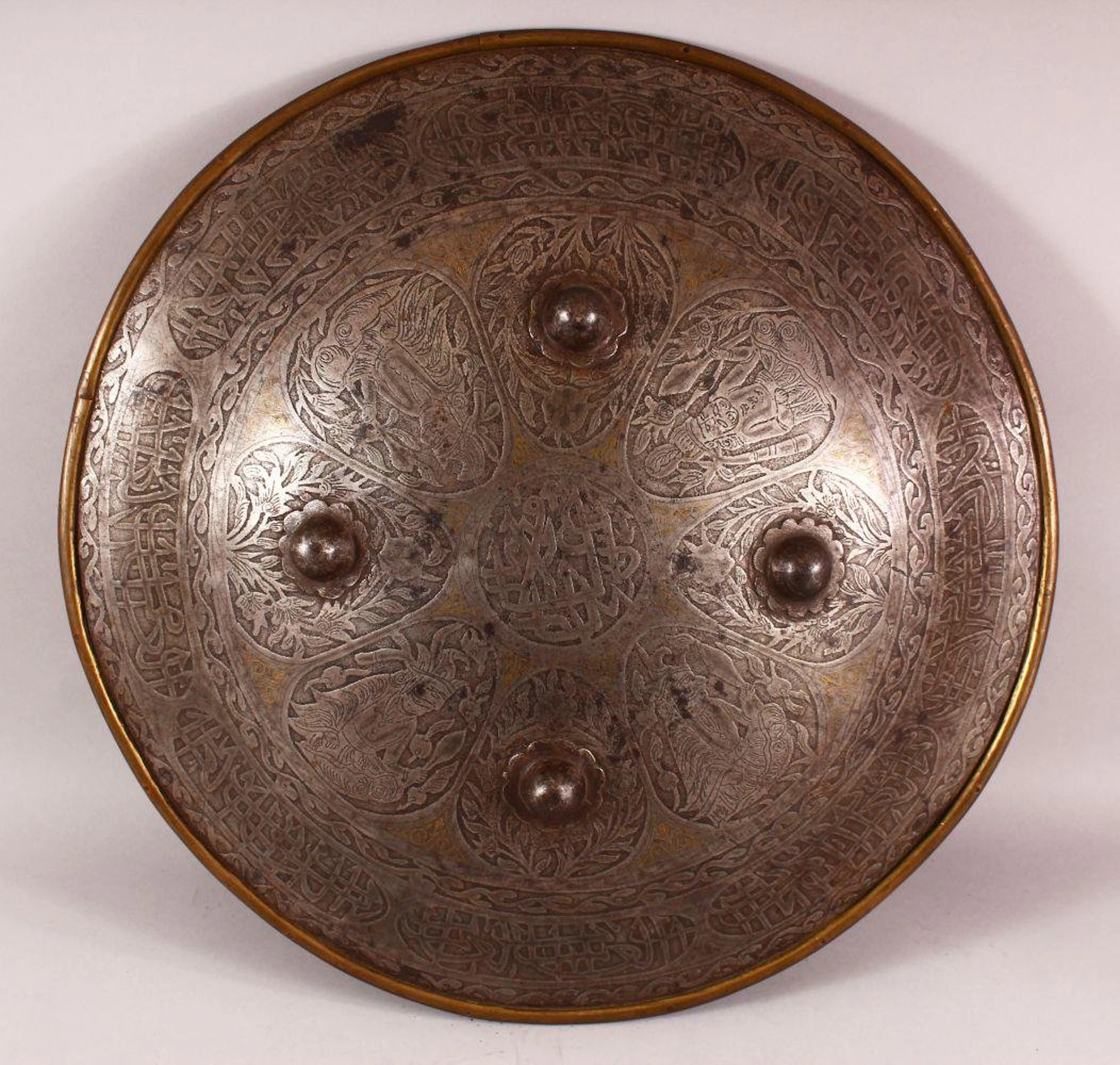 A PERSIAN QAJAR STEEL SHEILD, with etched decoration of