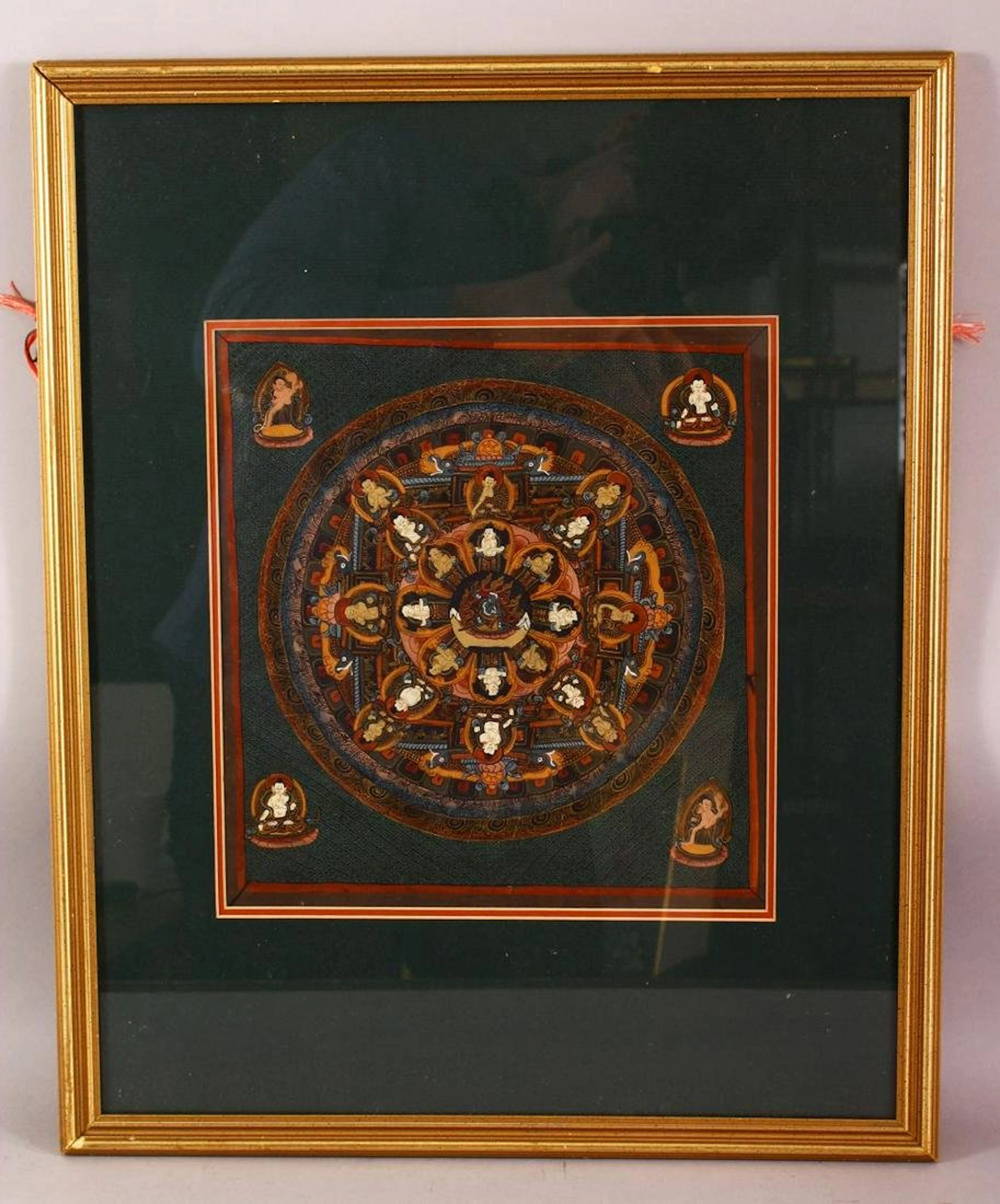 A SMALL FRAMED HAND PAINTED TIBETAN THANGKA, the