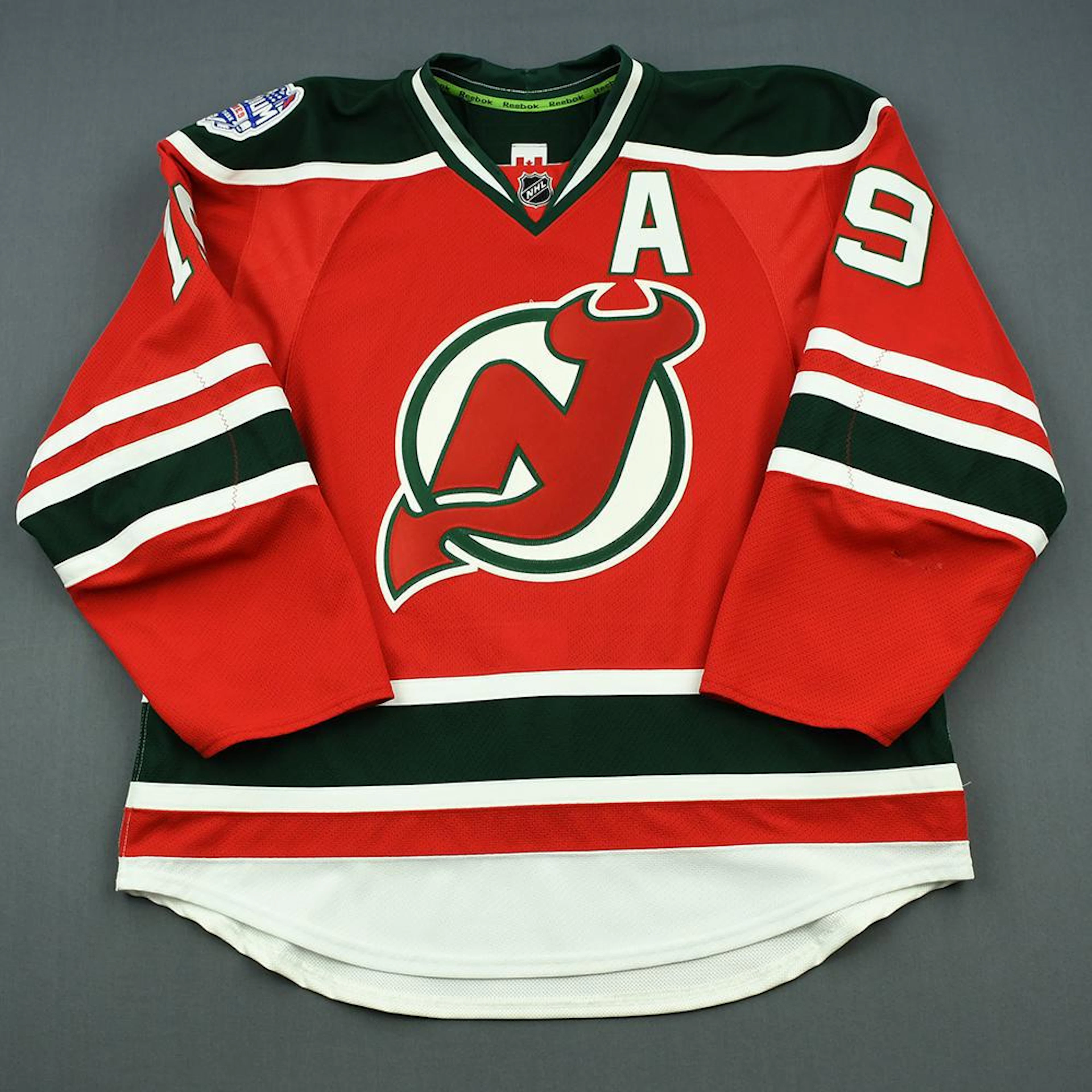 Travis Zajac - Game-Worn Red w/A Stadium Series Jersey...