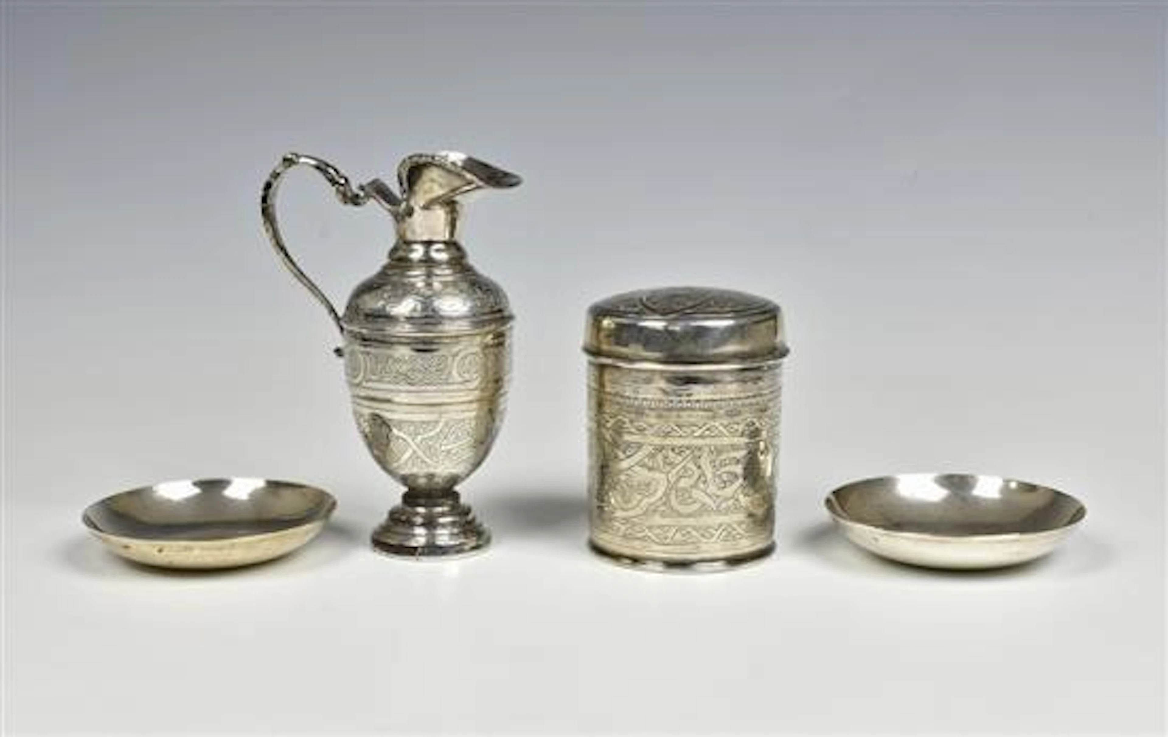 A Egyptian silver cylindrical lidded jar lotus flower...