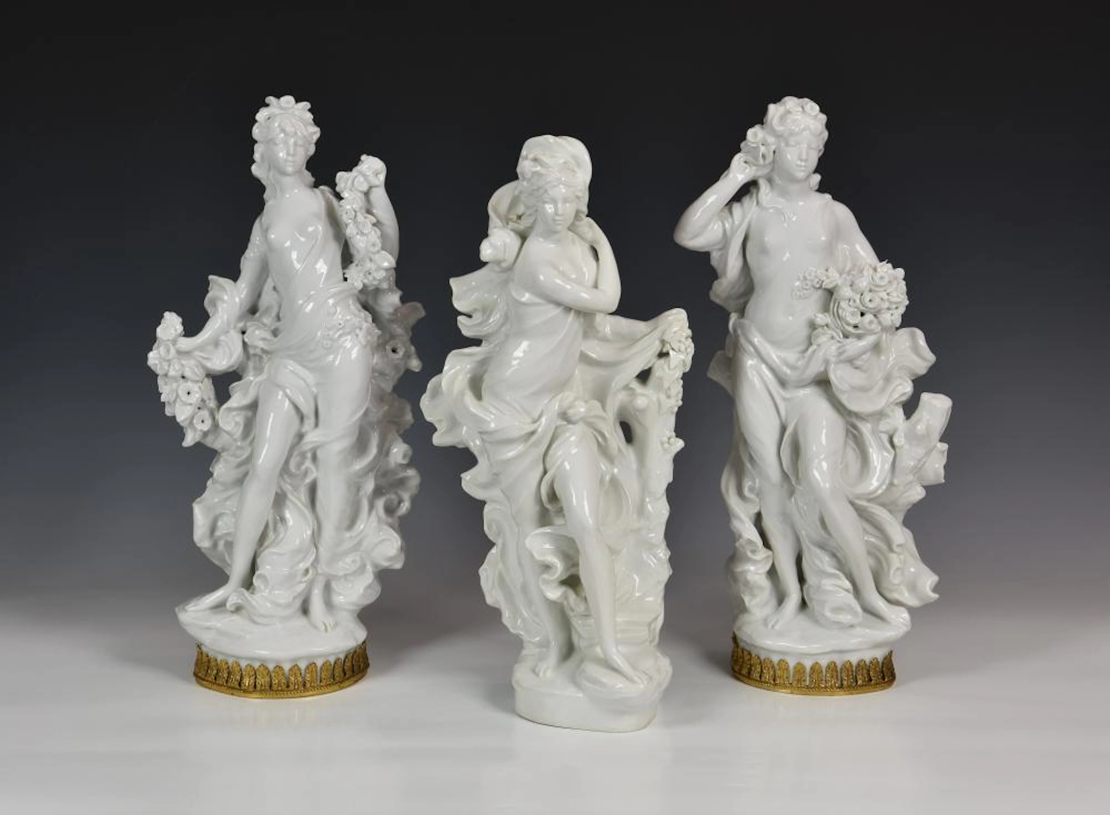 A set of three large Royal Worcester figures from The Four Seasons