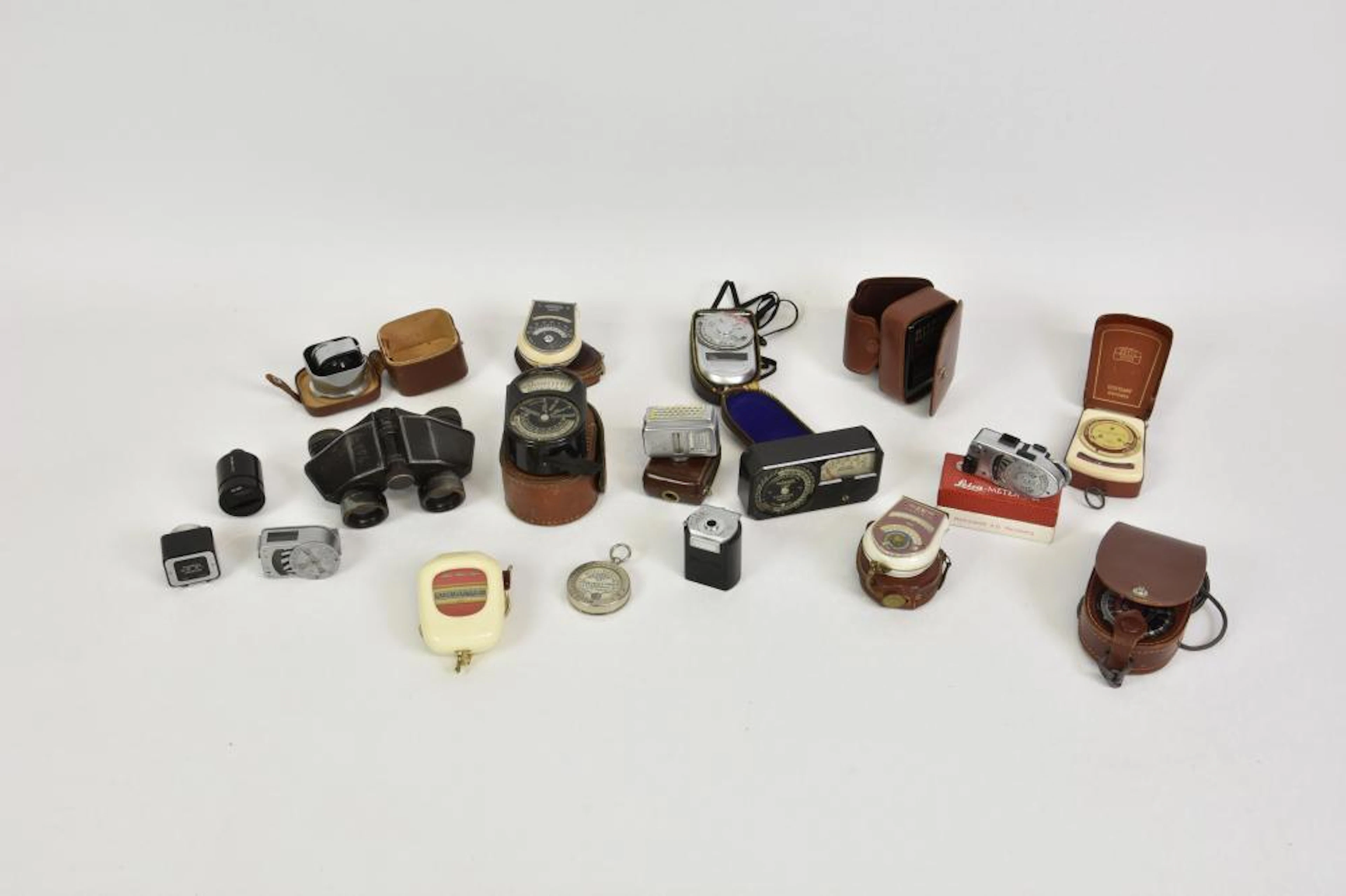 A collection of various vintage light / exposure meters and view finders etc