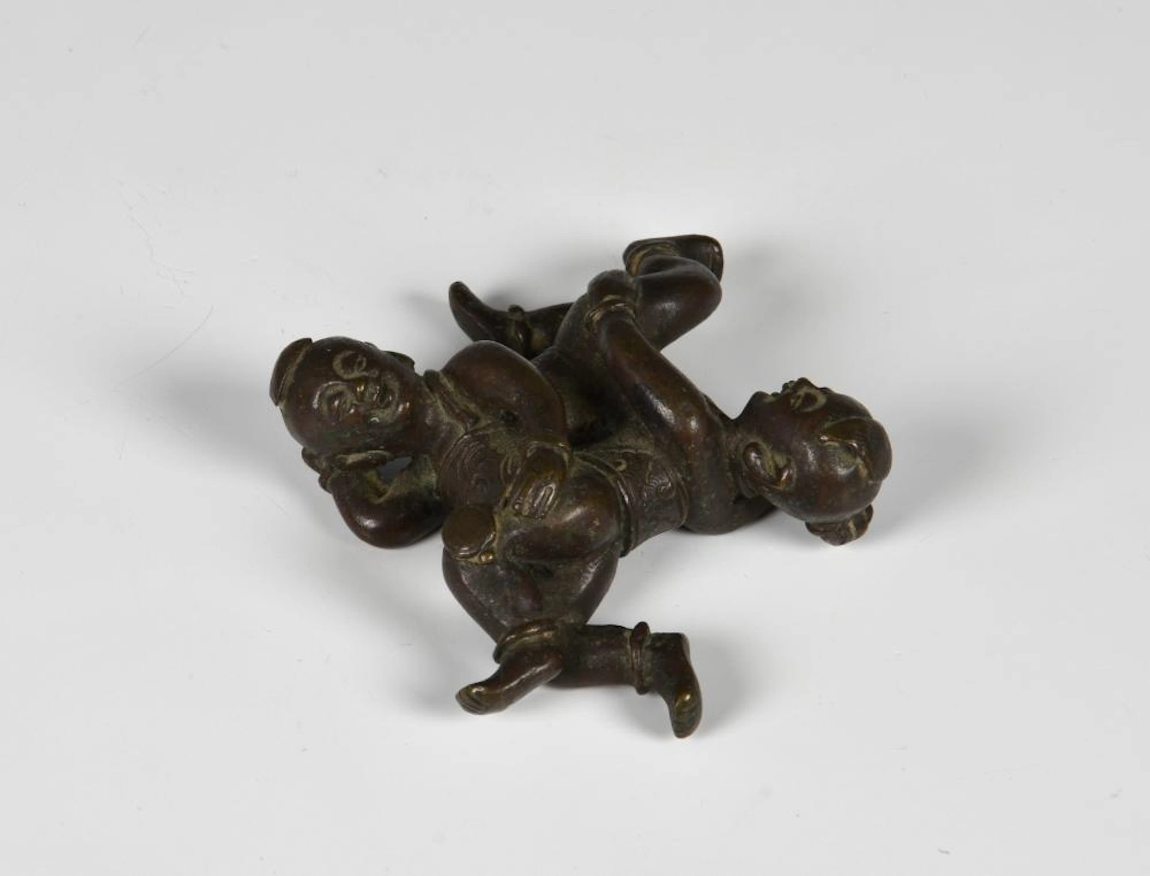 An antique Chinese bronze figure / scroll weight of 'Si...