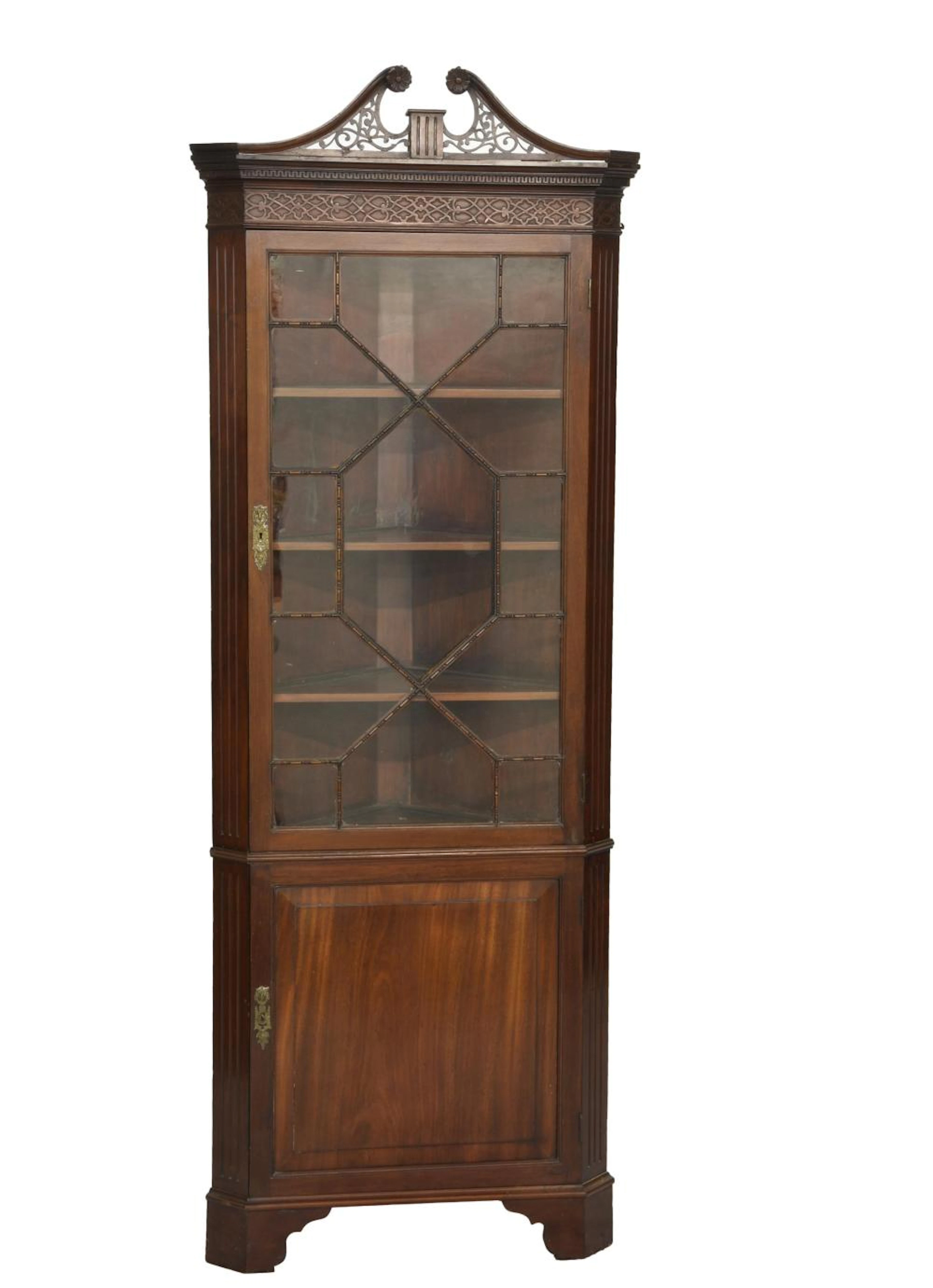 An Edwardian mahogany George III style glazed corner cabinet