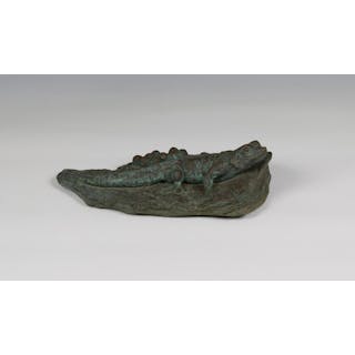 A patinated bronze sculpture of a lizard