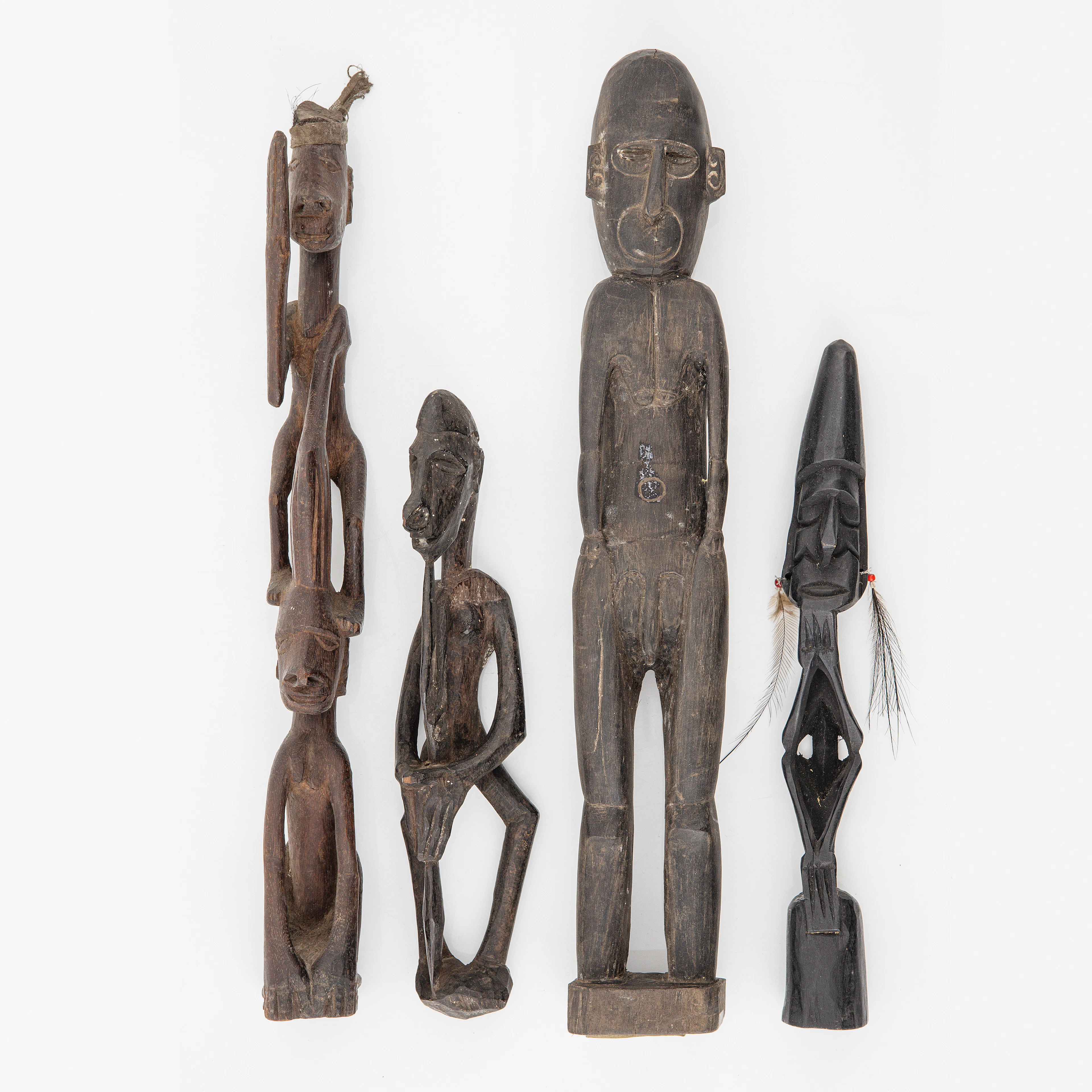 A group of four Asmat wood carvings/sculptures
