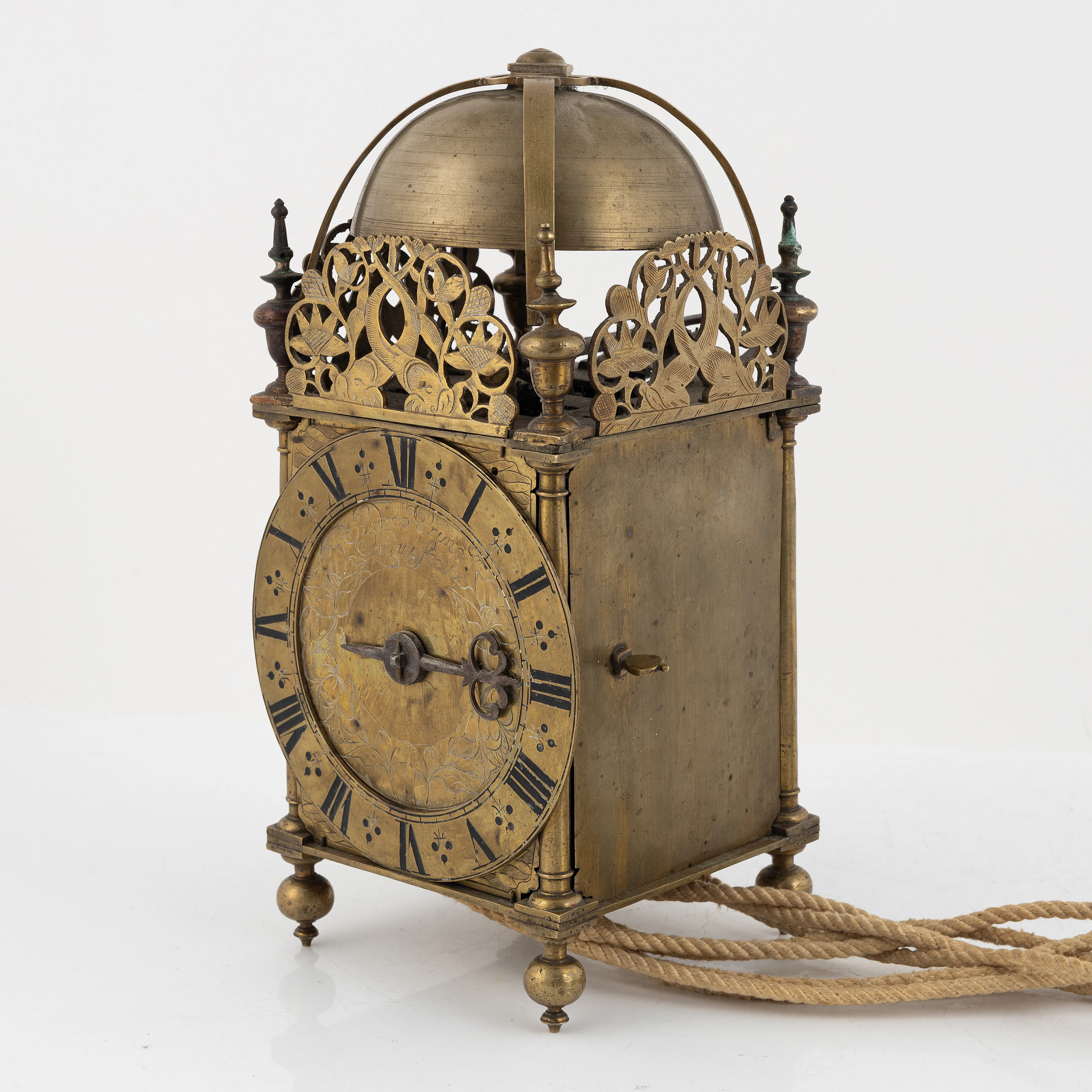 A Baroque brass lantern clock with bracket marked Andrew...