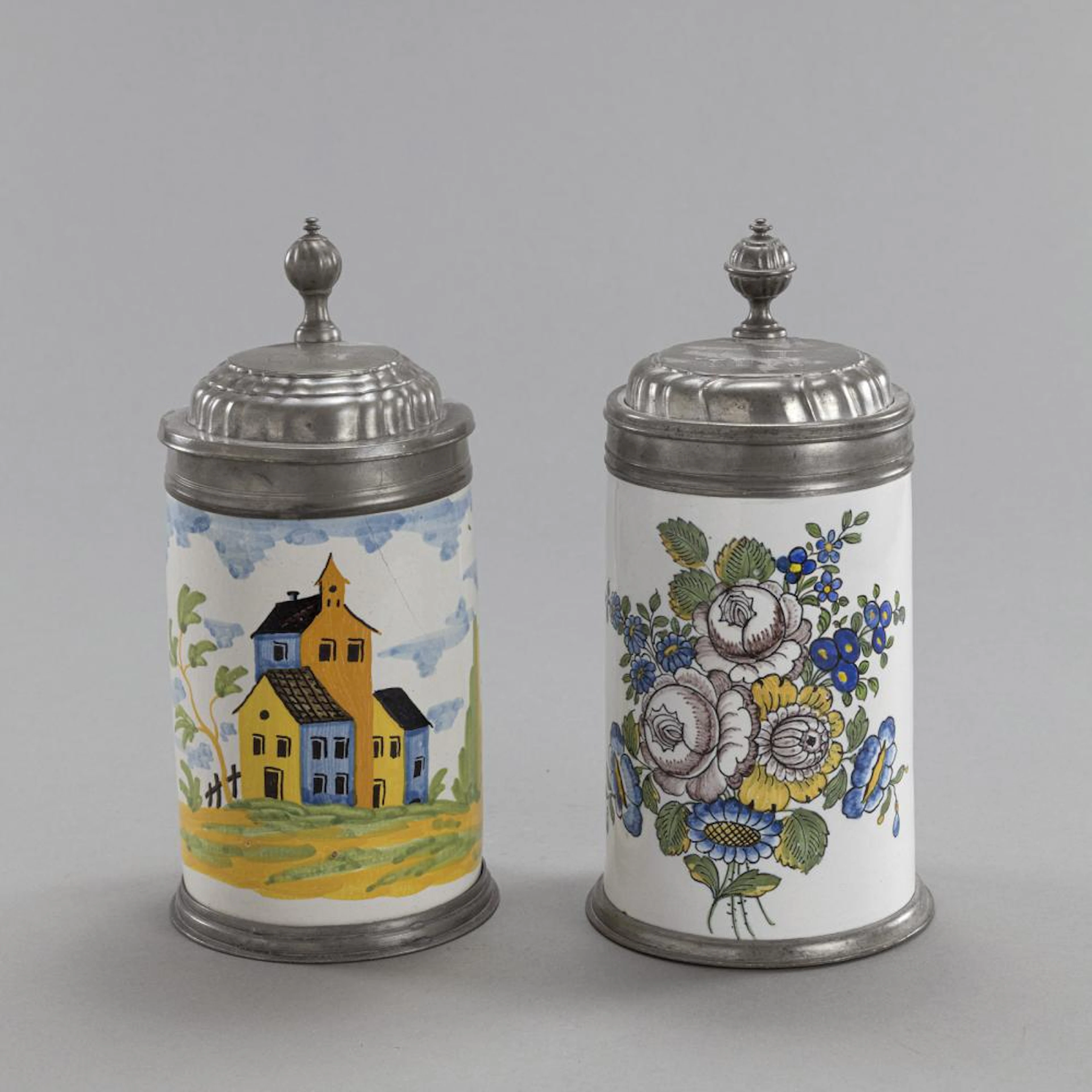 TWO SCHREZHEIM PEWTER MOUNTED FAYENCE TANKARDS