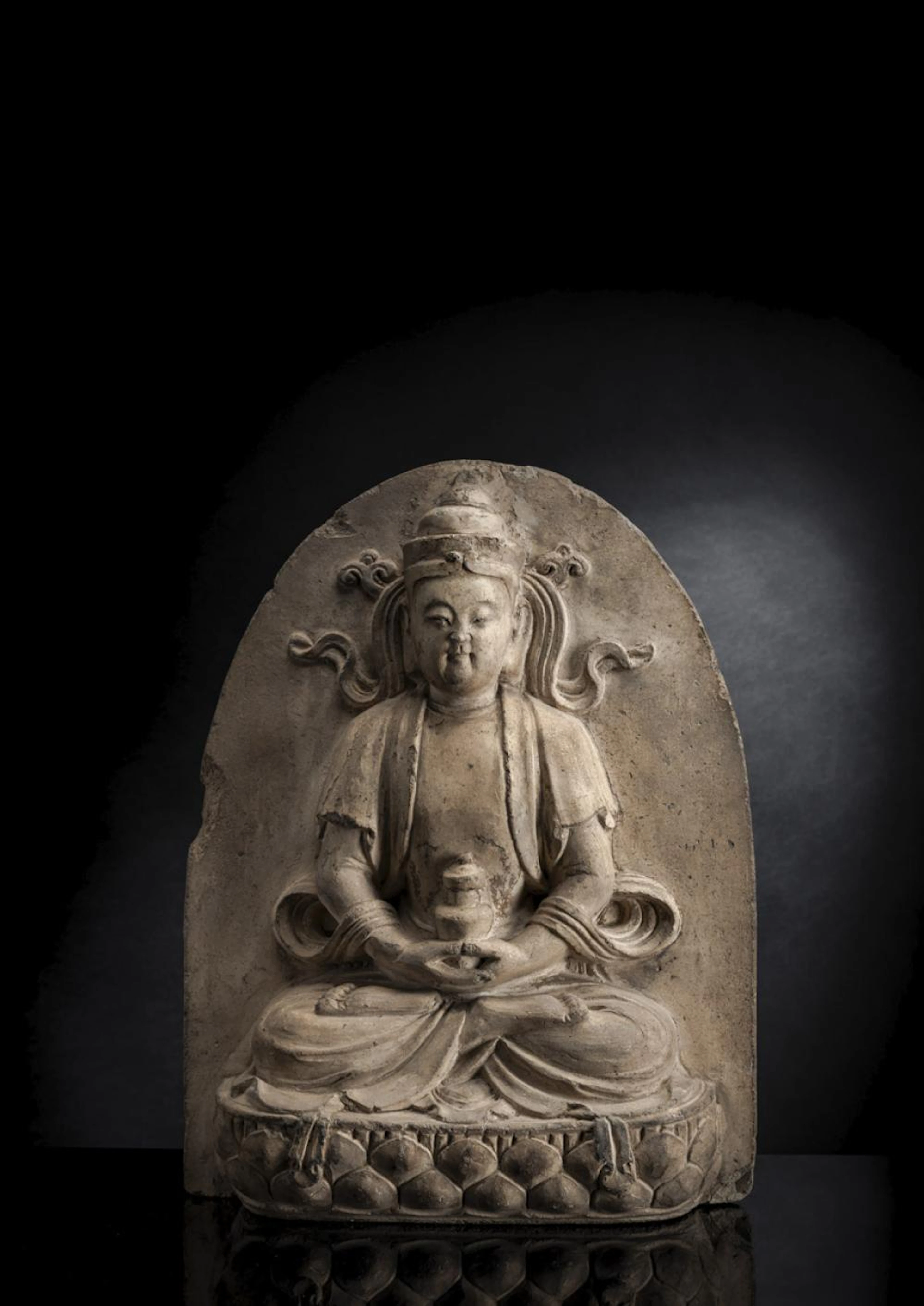 AN UNUSUAL UNGLAZED POTTERY FIGURE OF BUDDHA SEATED ON A LOTUS