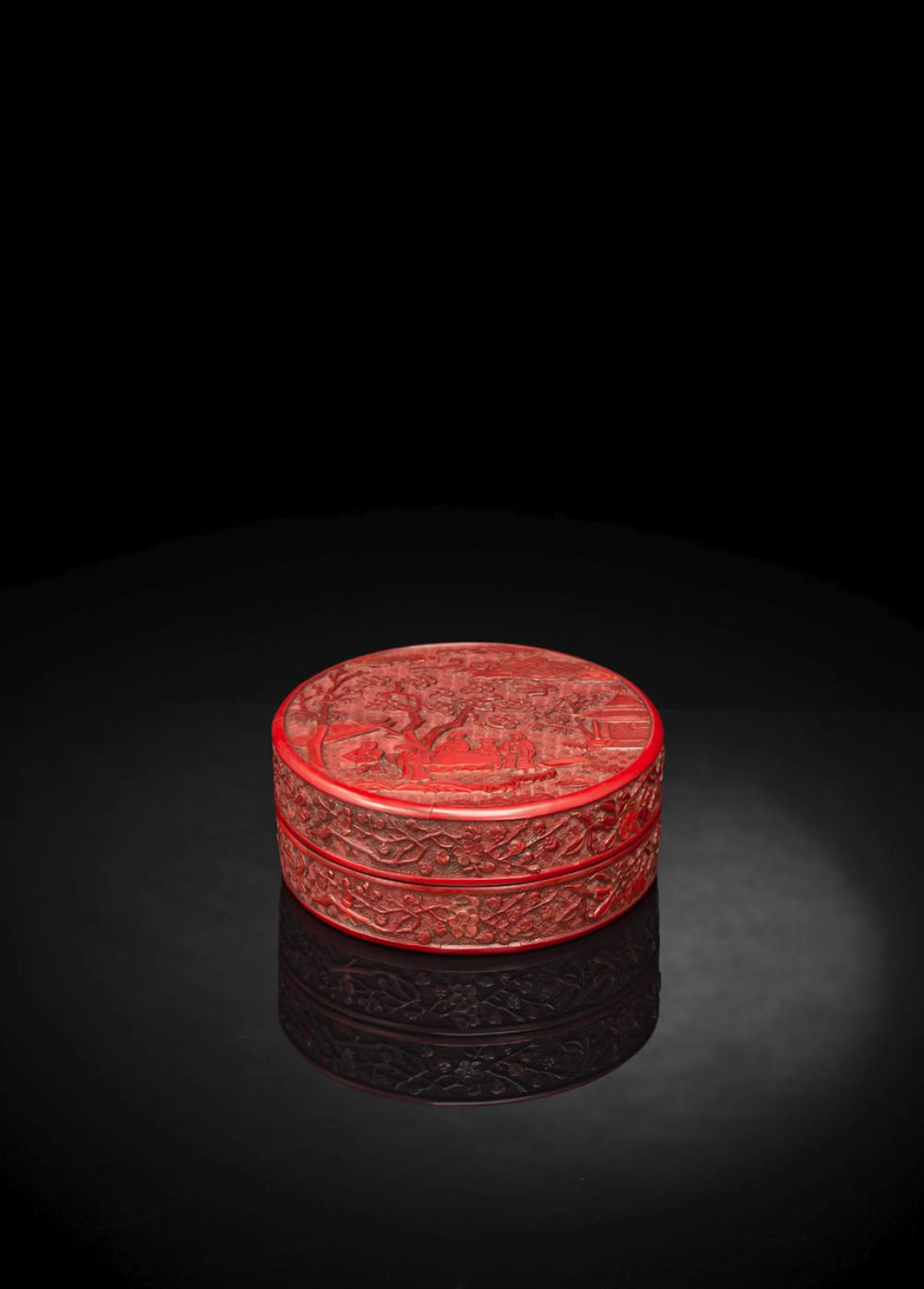 A RARE CARVED CIRCULAR CINNABAR LACQUER BOX AND COVER