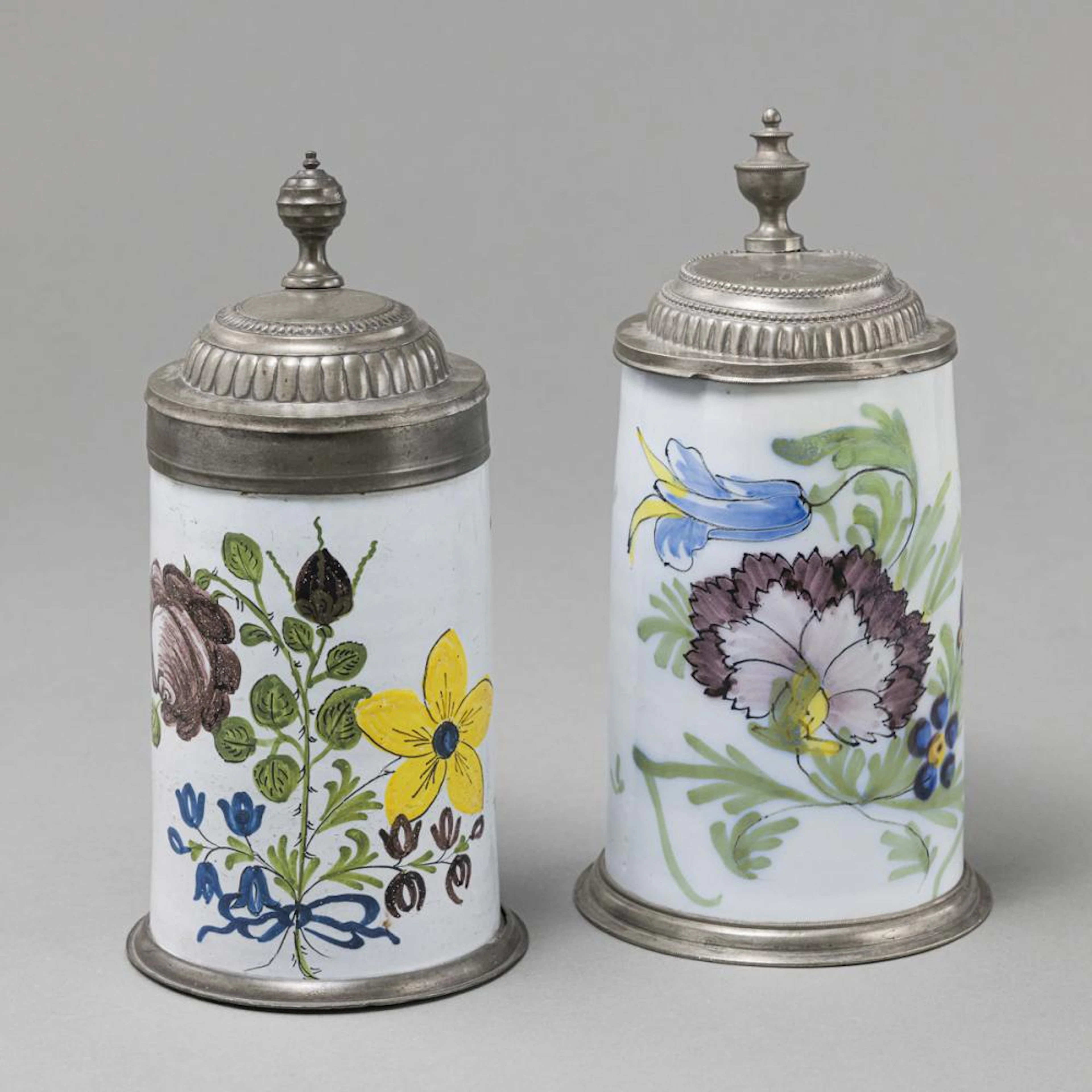 TWO GERMAN FAIENCE TANKARDS