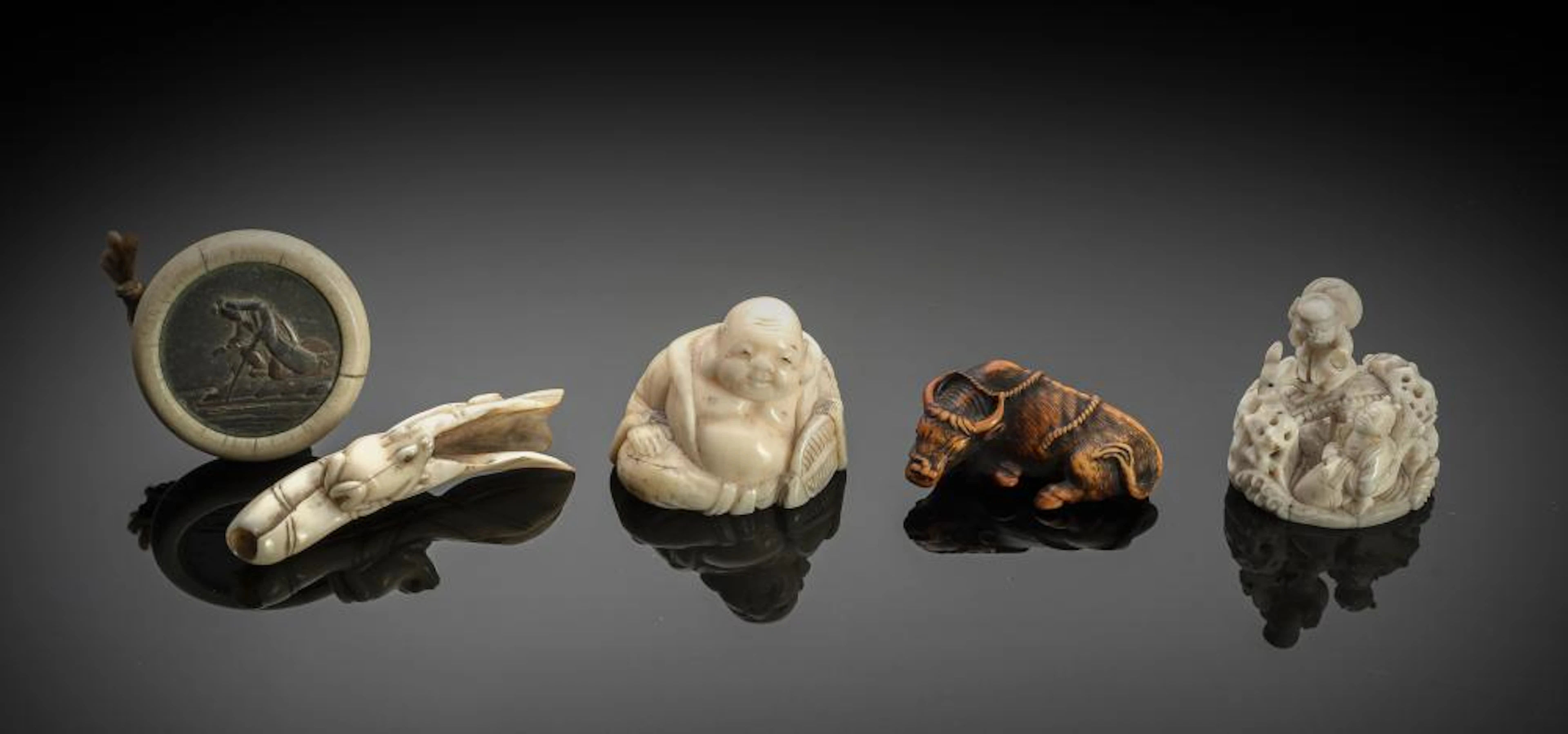 FOUR CARVED IVORY NETSUKE AND A KAGAMIBUTA: HOTEI