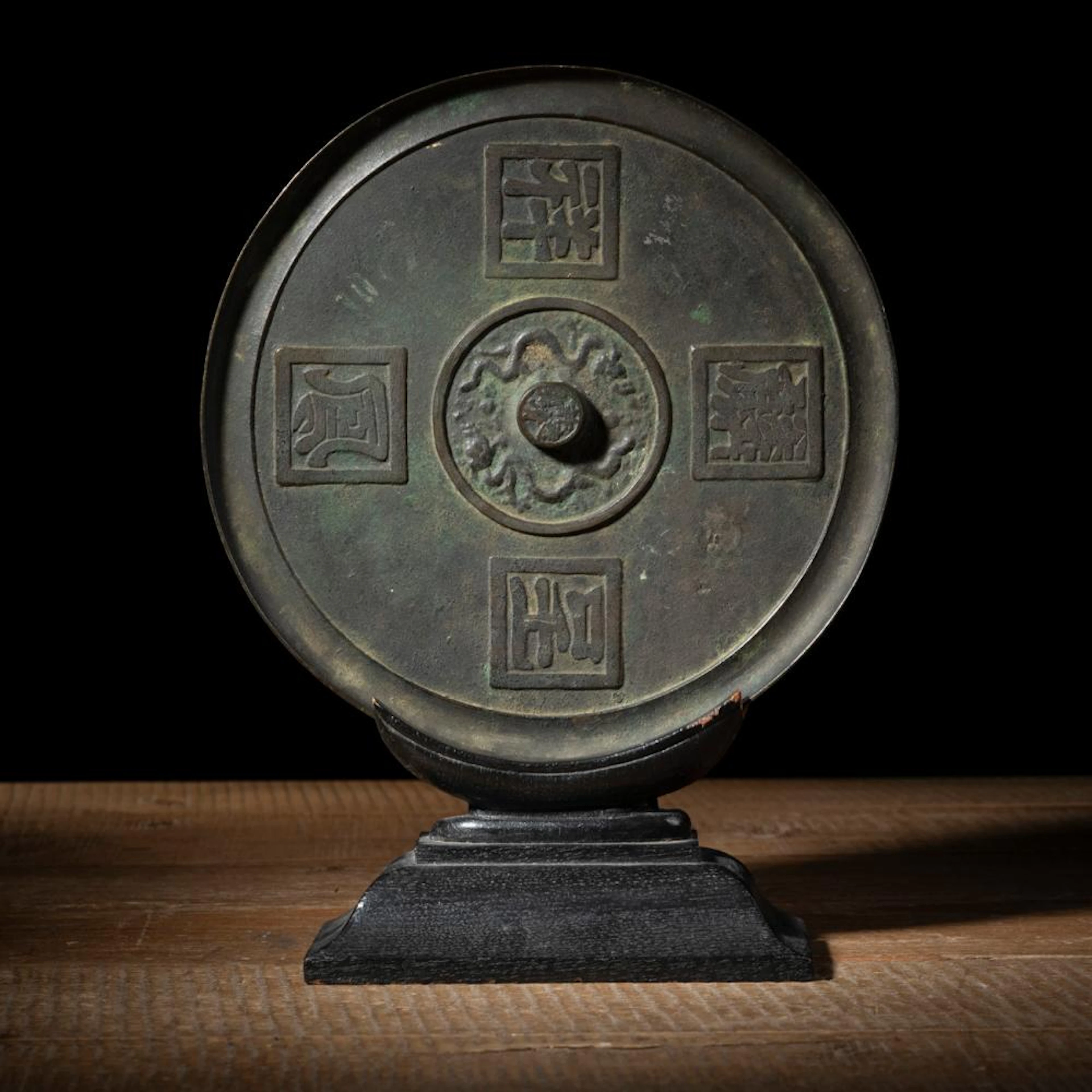 A RELIEF INSCRIBED 'LONG FENG CHENG XIANG' BRONZE MIRROR
